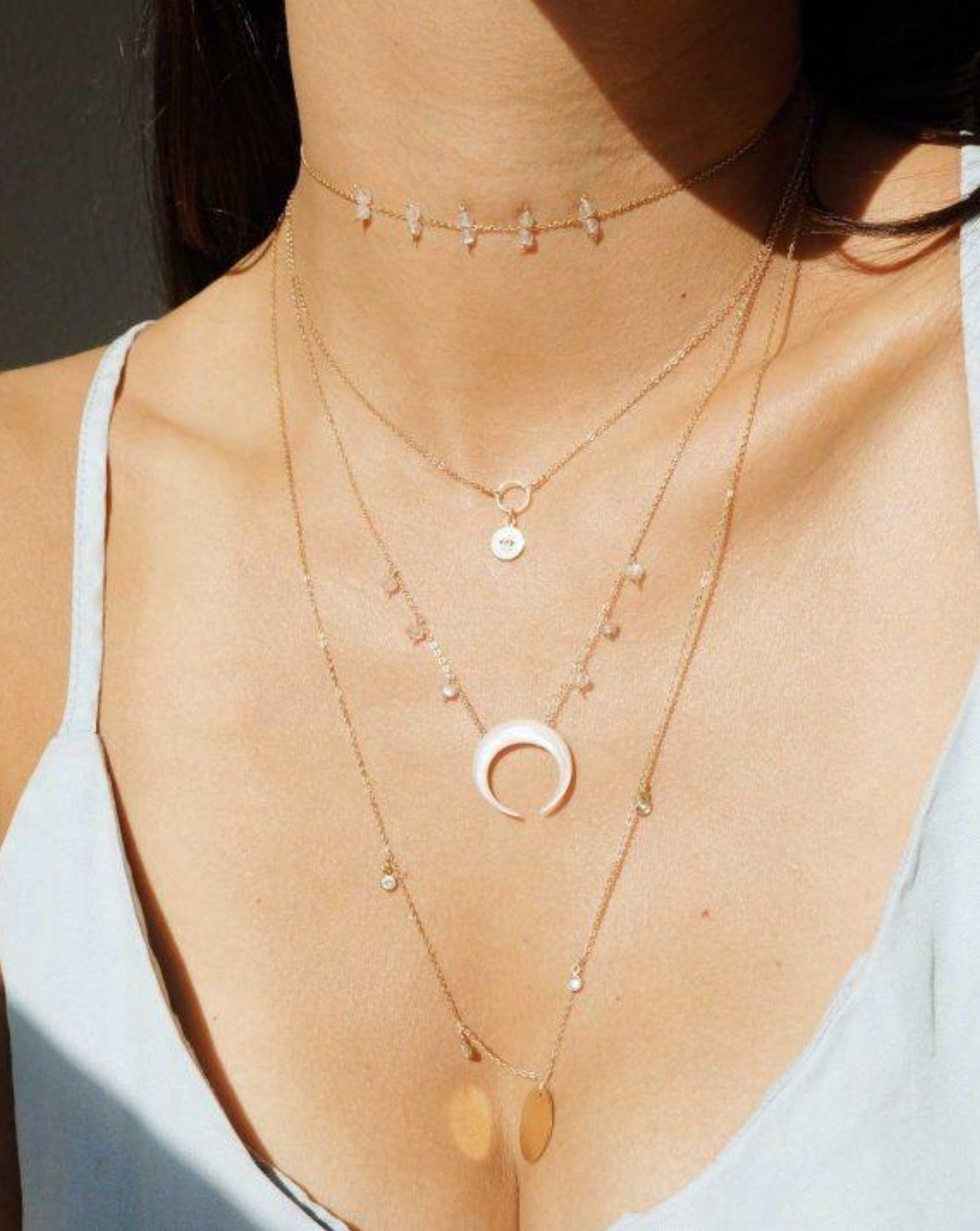 Baque Moon Necklace by KOZAKH. A 16 to 18 inch adjustable length necklace in 14K Gold Filled, featuring a 20mm hand-carved Mother of Pearl moon charm and 2mm faceted Moonstones.