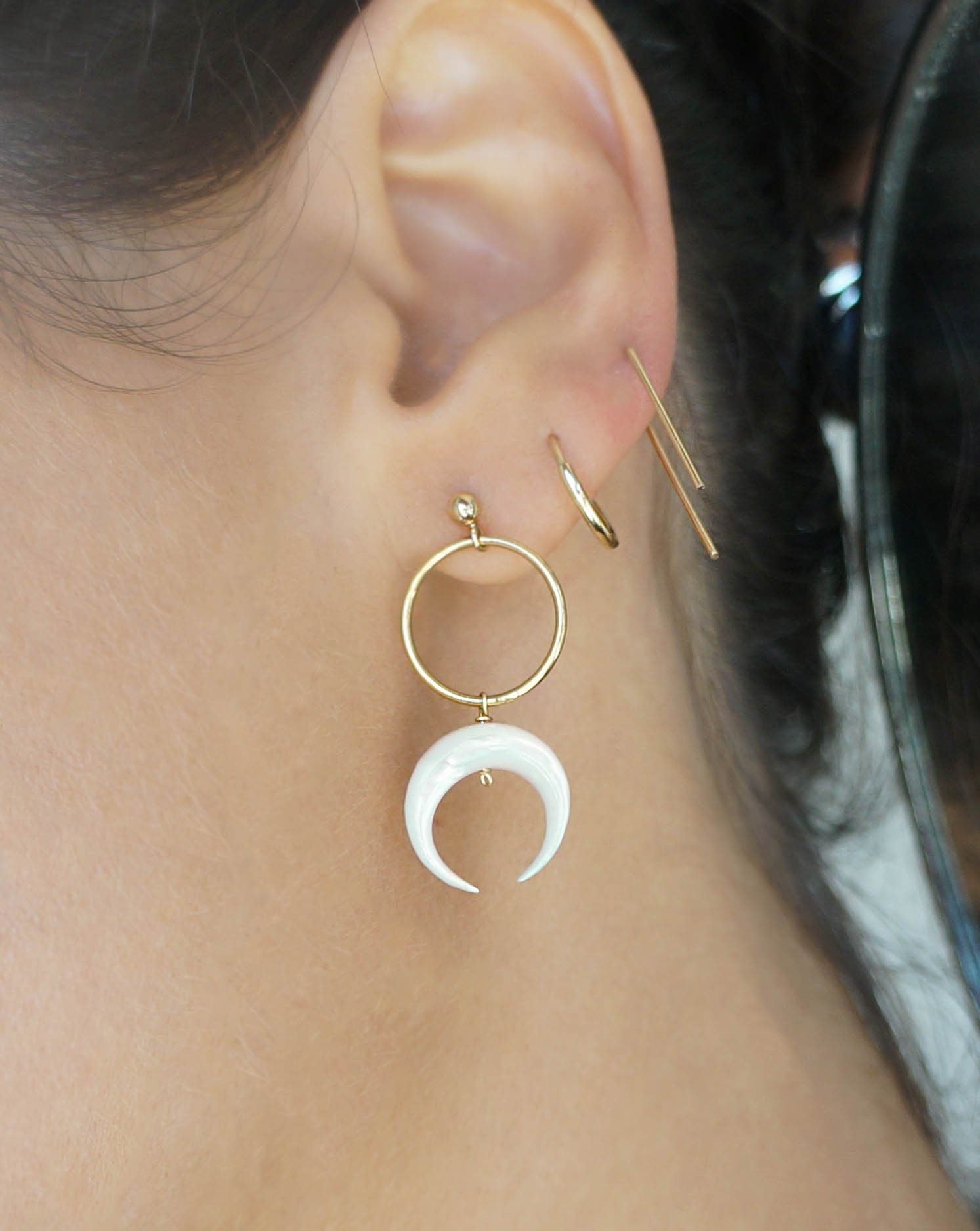 Baques Earrings by KOZAKH. Dangling earrings in 14K Gold Filled, featuring a hand-carved Mother of Pearl moon charm.