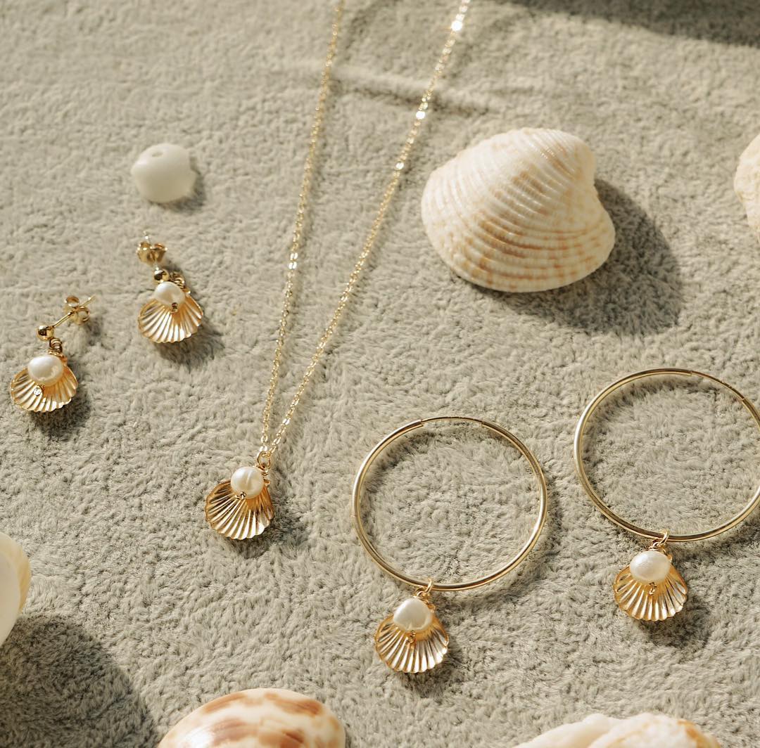 Belle Hoop Earrings by KOZAKH. A 30mm hoop earrings in 14K Gold Filled, featuring a 5mm flat irregular Pearl and a Shell charm.