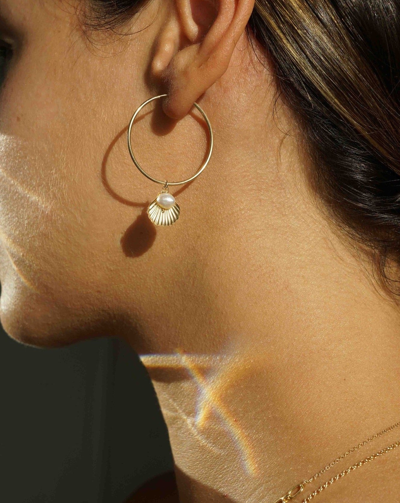 Belle Hoop Earrings by KOZAKH. A 30mm hoop earrings in 14K Gold Filled, featuring a 5mm flat irregular Pearl and a Shell charm.