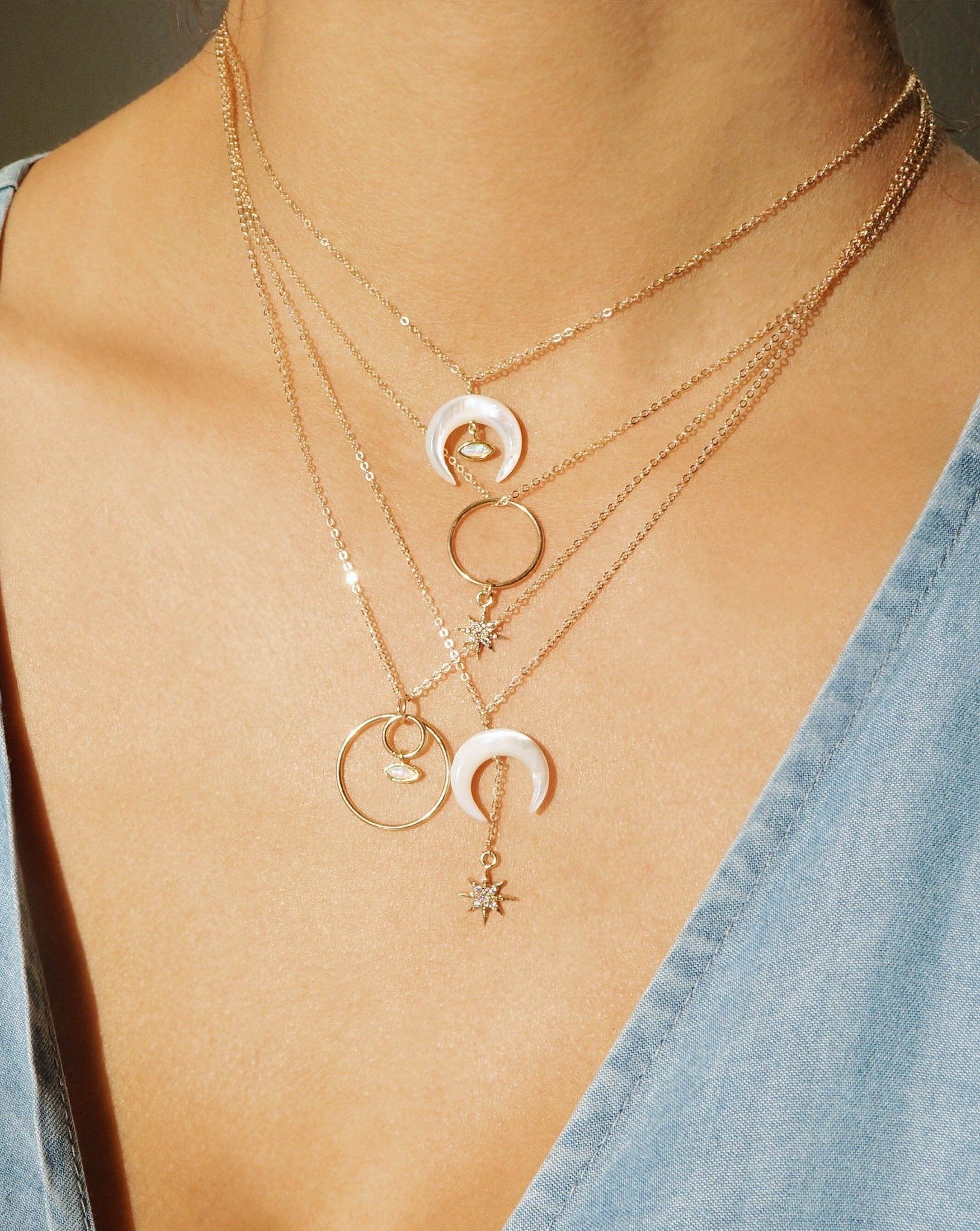 Brillar Necklace by KOZAKH. A 16 to 18 inch adjustable length necklace in 14K Gold Filled, featuring a Marquise Opal charm and a hand carved Mother of Pearl crescent moon charm.