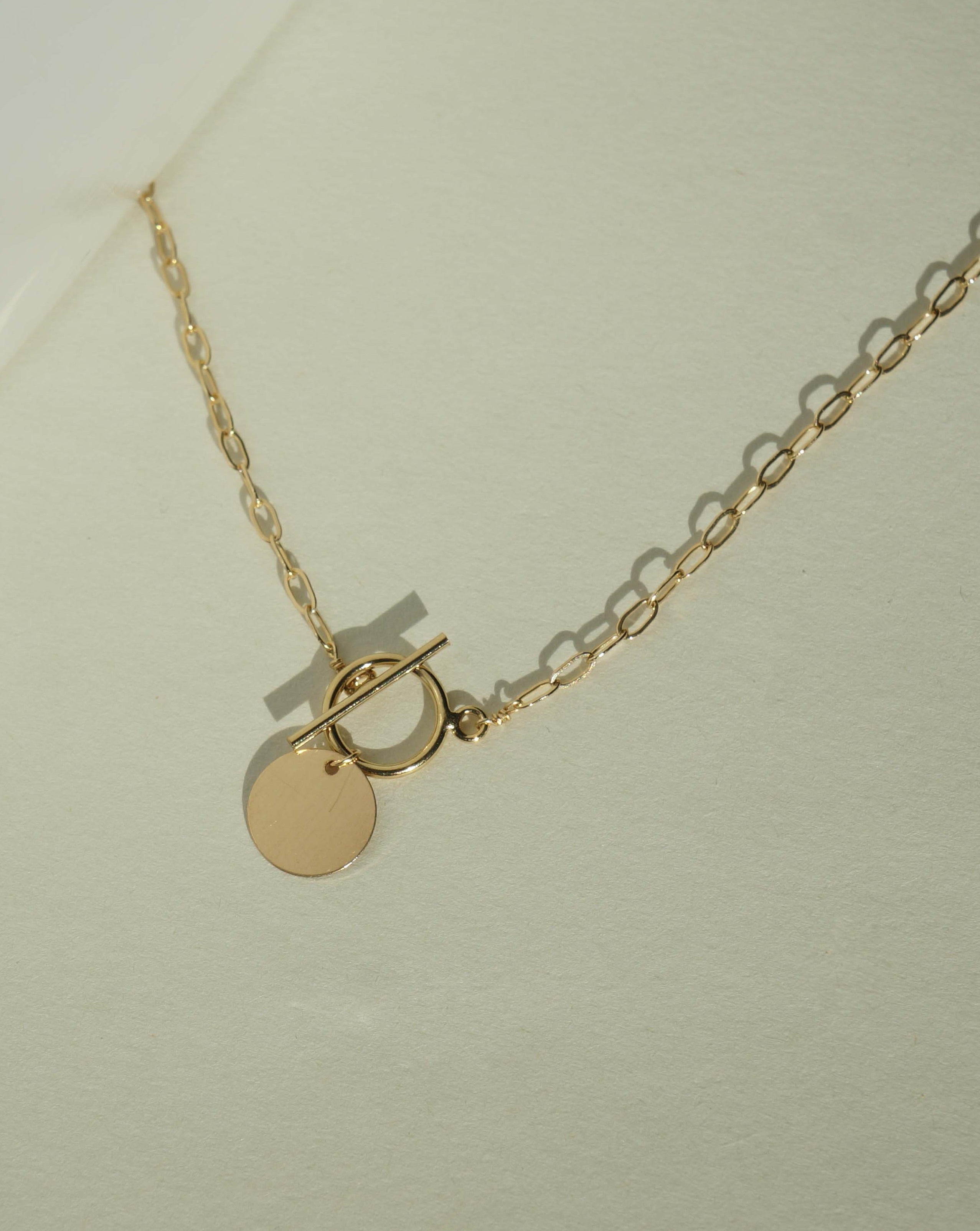 Cappa Necklace by KOZAKH. A 16 to 18 inch adjustable length necklace in 14K Gold Filled, featuring a coin charm.