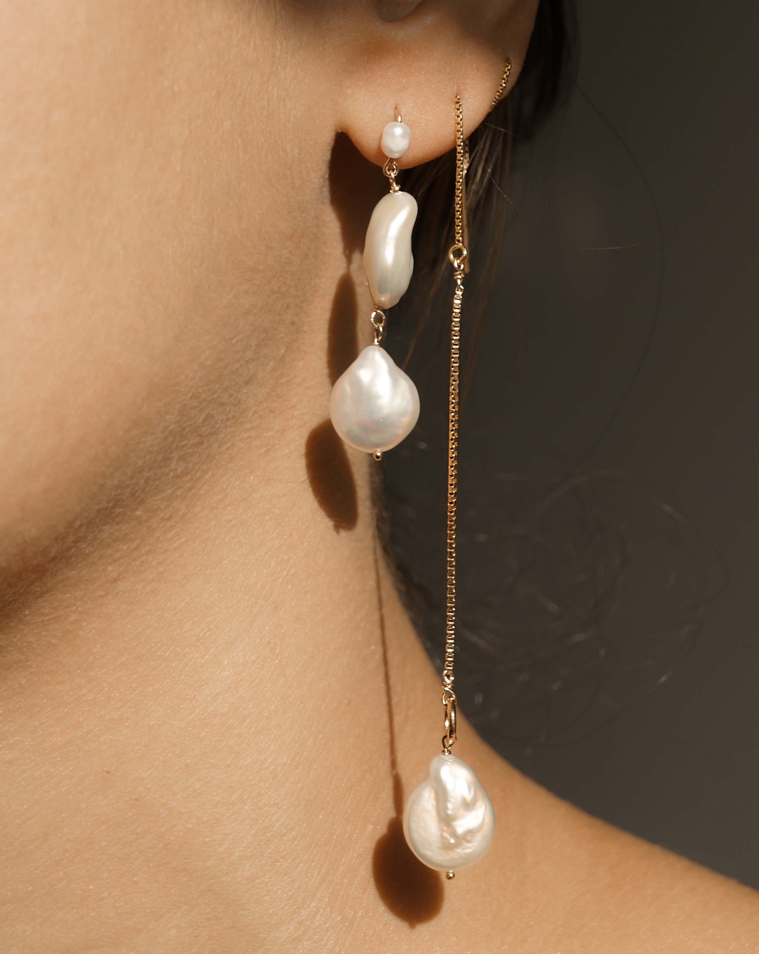 Caro Earrings by KOZAKH. Dangling earrings in 14K Gold Filled with an earring drop length of 2 inches, featuring Freshwater Baroque Pearls.