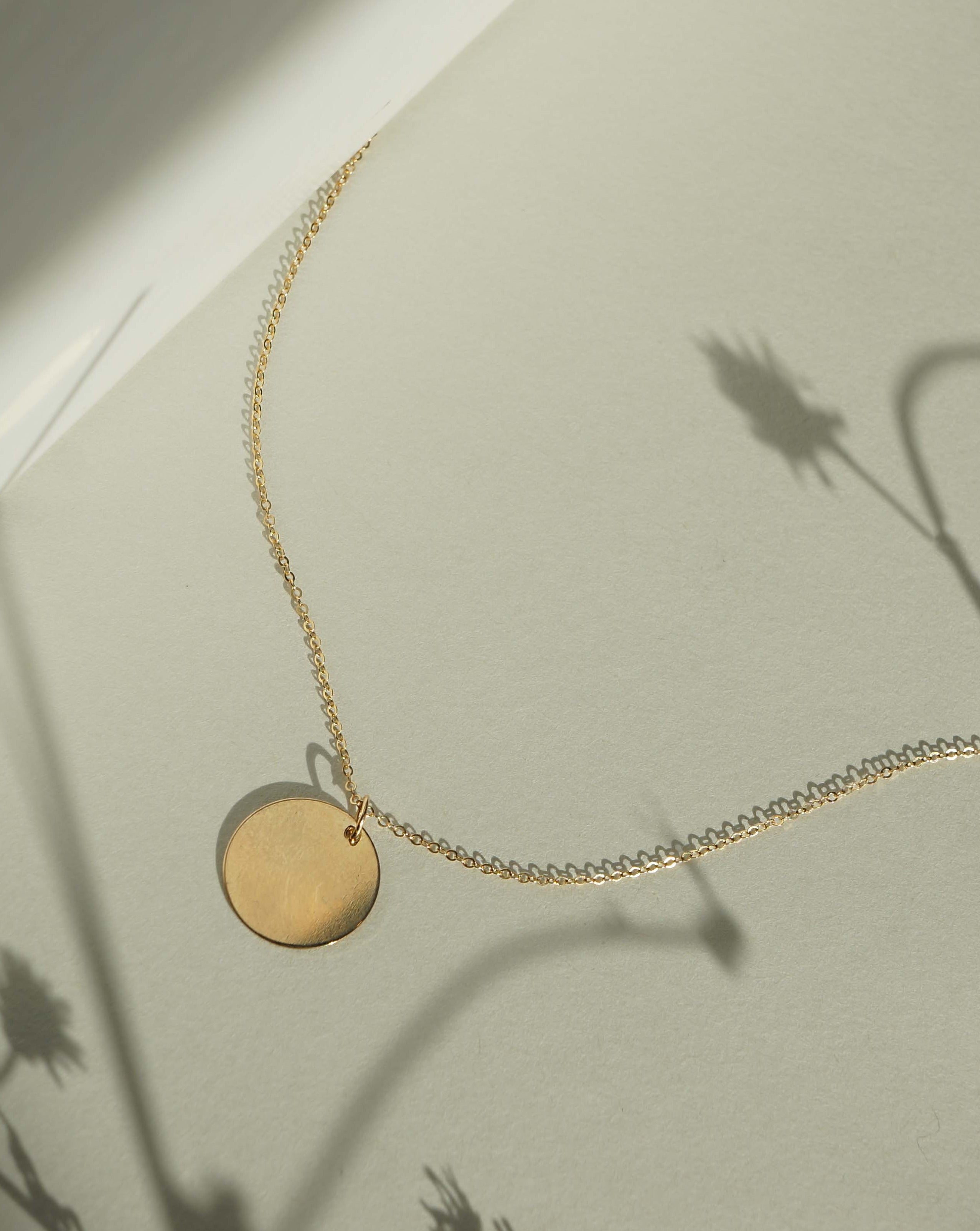 Chloe Necklace by KOZAKH. A 16 inch long Rollo chain necklace in 14K Gold Filled, featuring a 16mm Coin medallion.