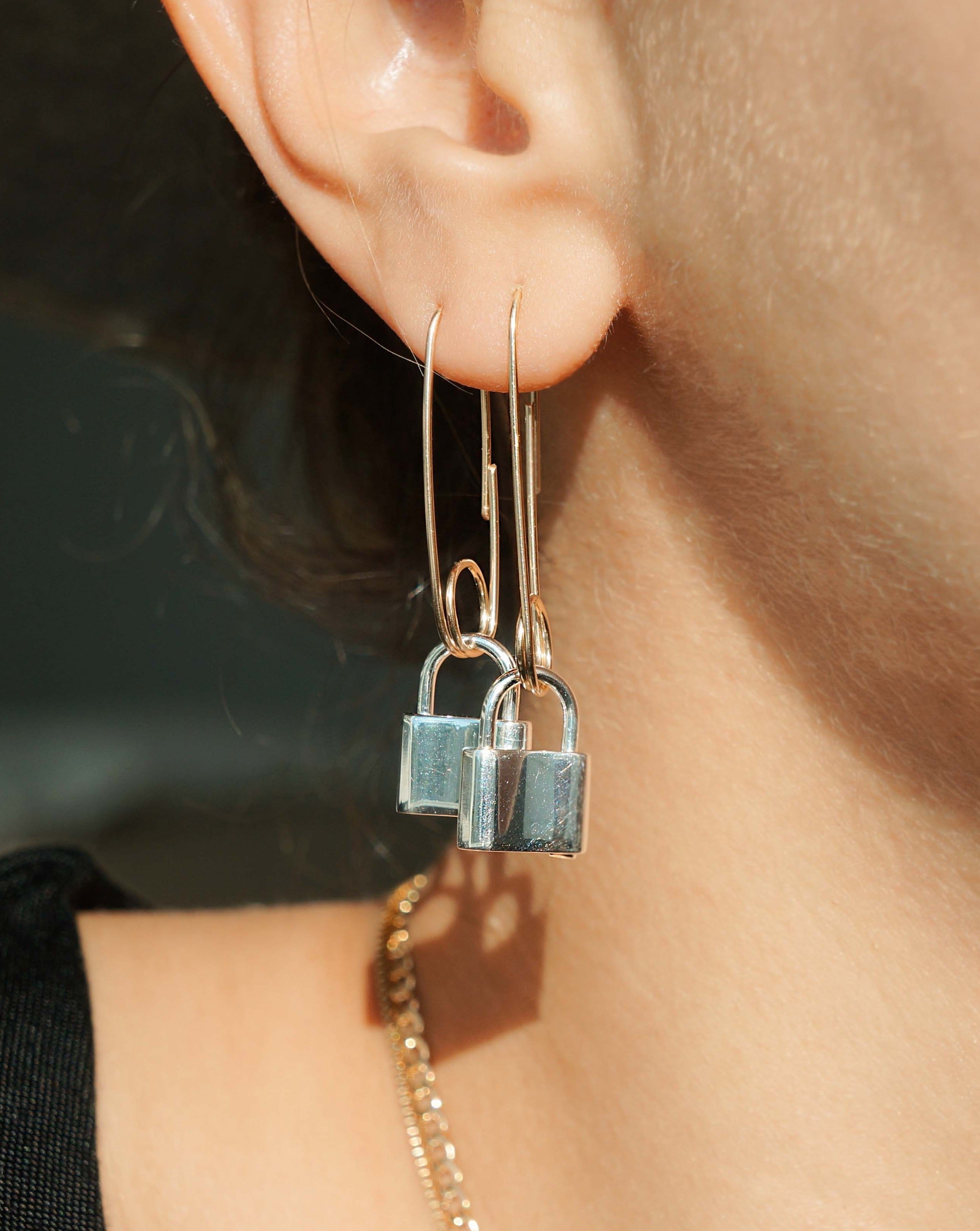 Clip Lock Earring Large by KOZAKH. A single paper clip style earring in 14K Gold Filled, featuring a silver lock.
