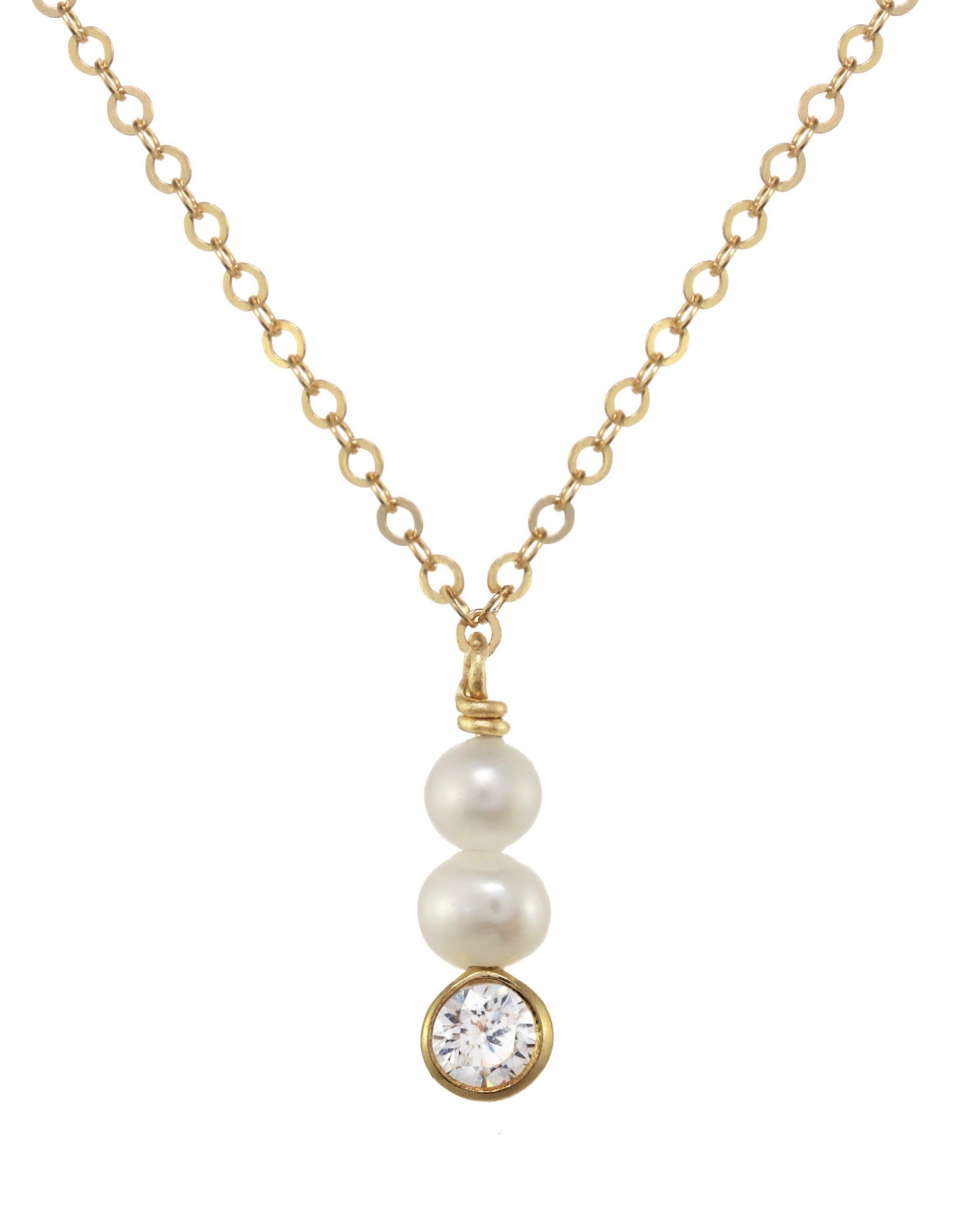 Coco Necklace by KOZAKH. A 16 to 18 inch adjustable length necklace in 14K Gold Filled, featuring 4mm to 5mm white round Pearls and a 3mm Cubic Zirconia bezel.