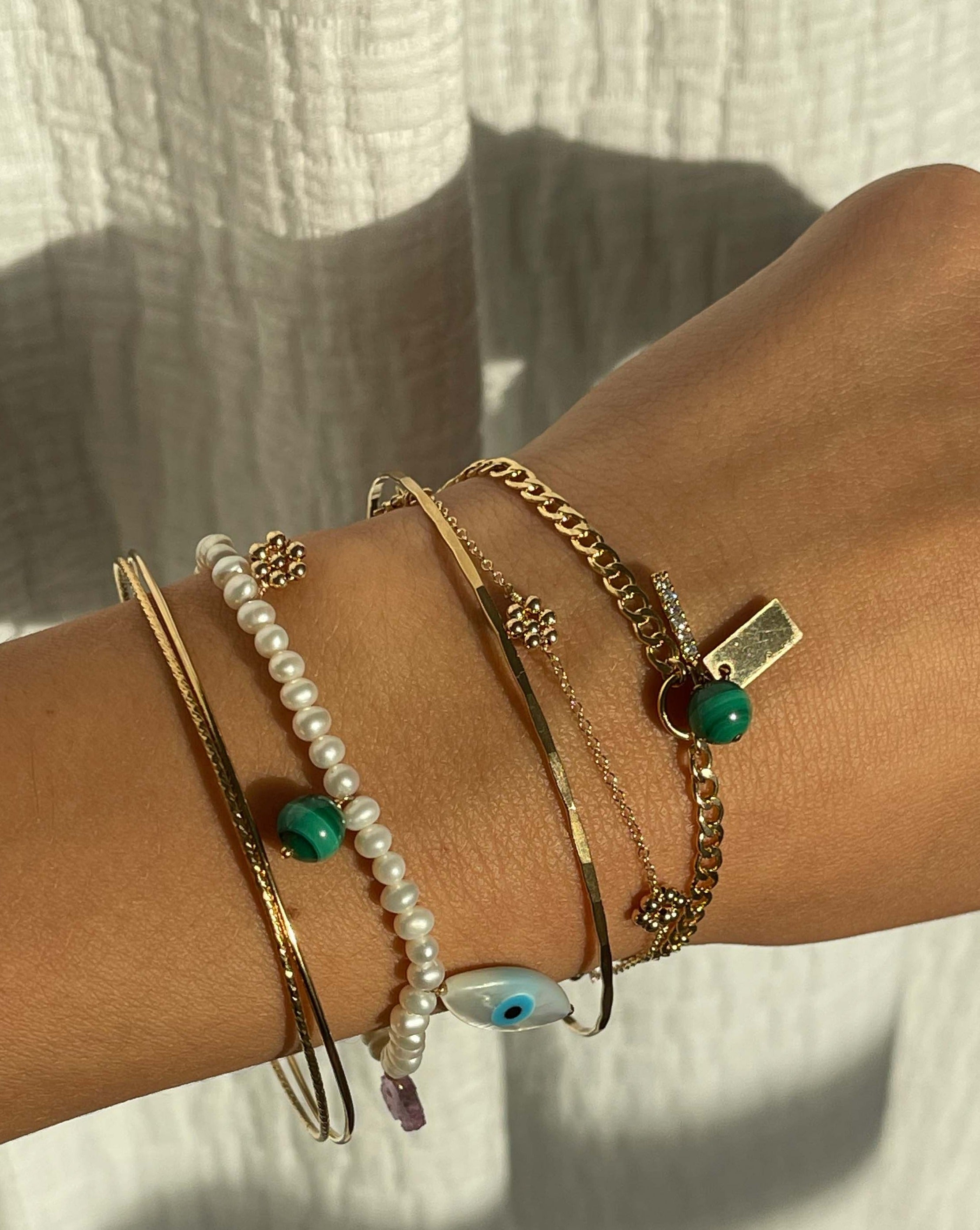 Davina Bracelet by KOZAKH. A 6 to 7 inch adjustable length bracelet, crafted in 14K Gold Filled, featuring handmade gold beaded daisies.