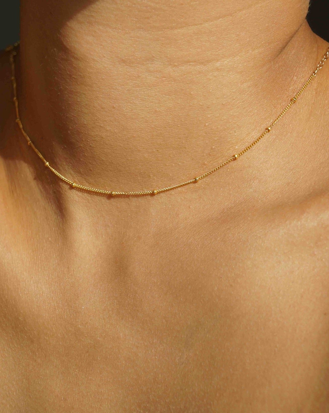 Dots Choker by KOZAKH. A 12 to 14 inch adjustable length necklace in 14K Gold Filled, featuring a 1mm curb chain with balls design.