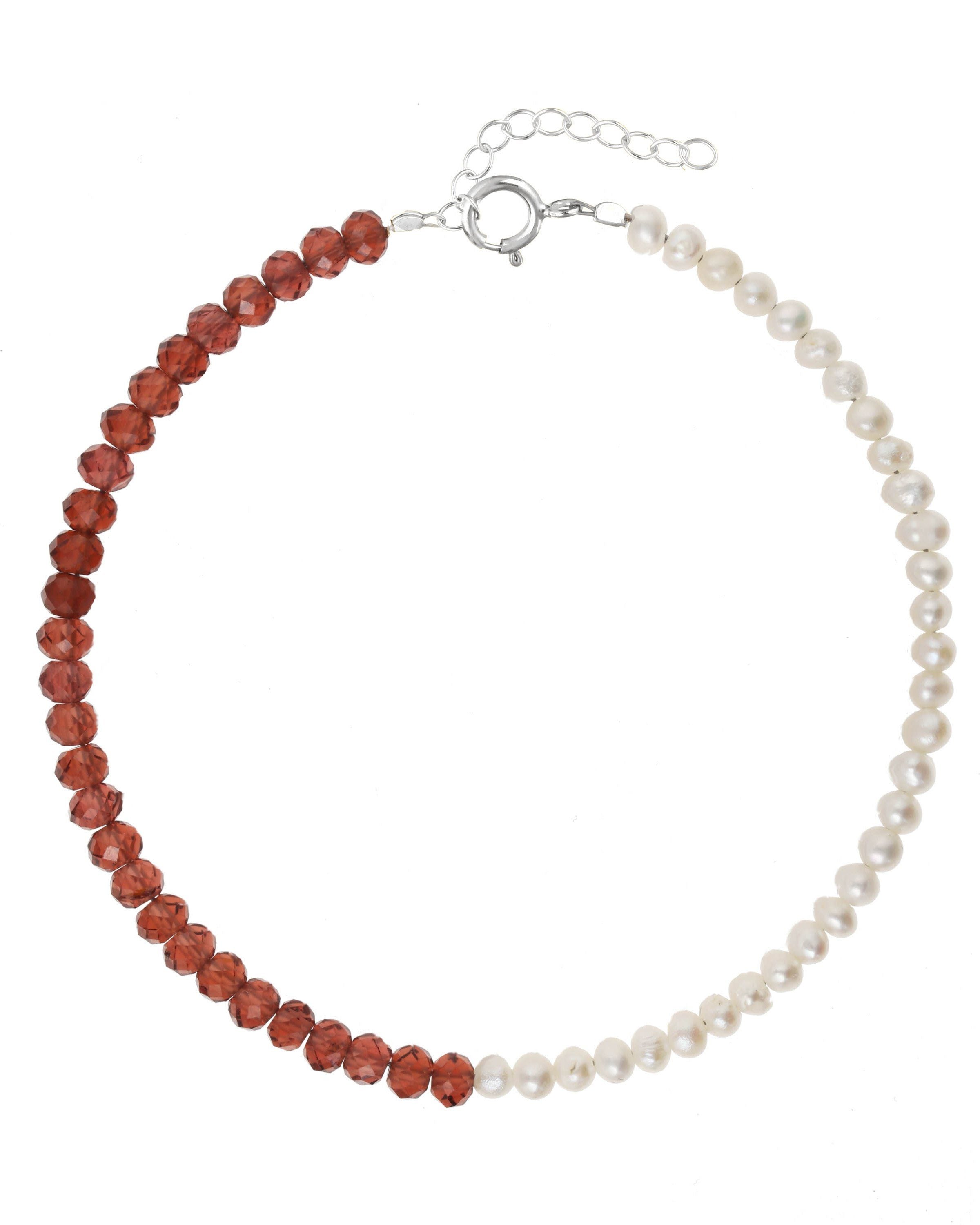 Elo Bracelet by KOZAKH. A 6 to 7 inch adjustable length bracelet, crafted in Sterling Silver. Half of the bracelet strand features 3.5mm Freshwater Pearls and 3.5mm Faceted Garnet beads on the other half.