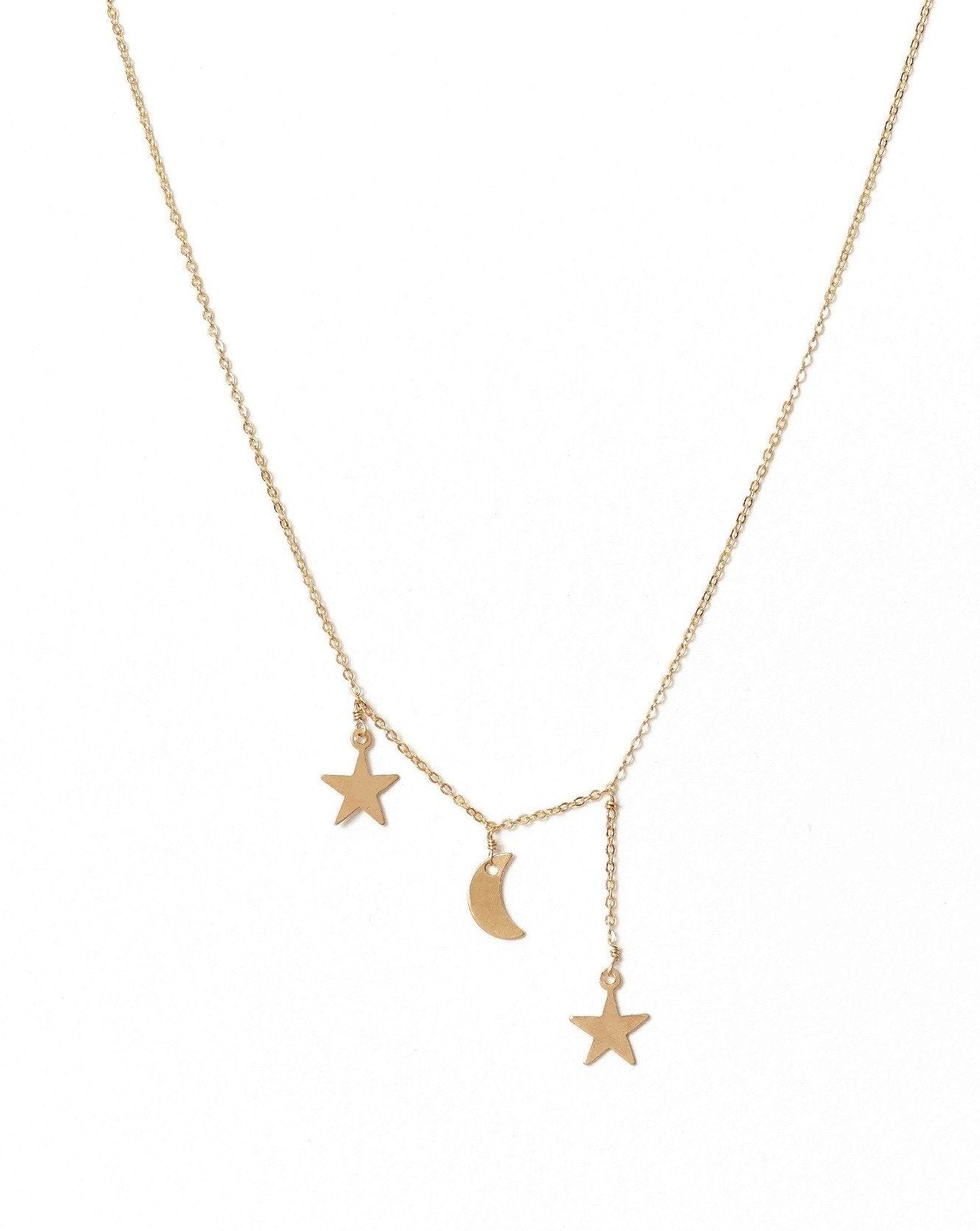 Filante Necklace by KOZAKH. A 16 to 18 inch adjustable length necklace in 14K Gold Filled, featuring moon and star charms with 1 star charm drop of about 0.5 inch. 