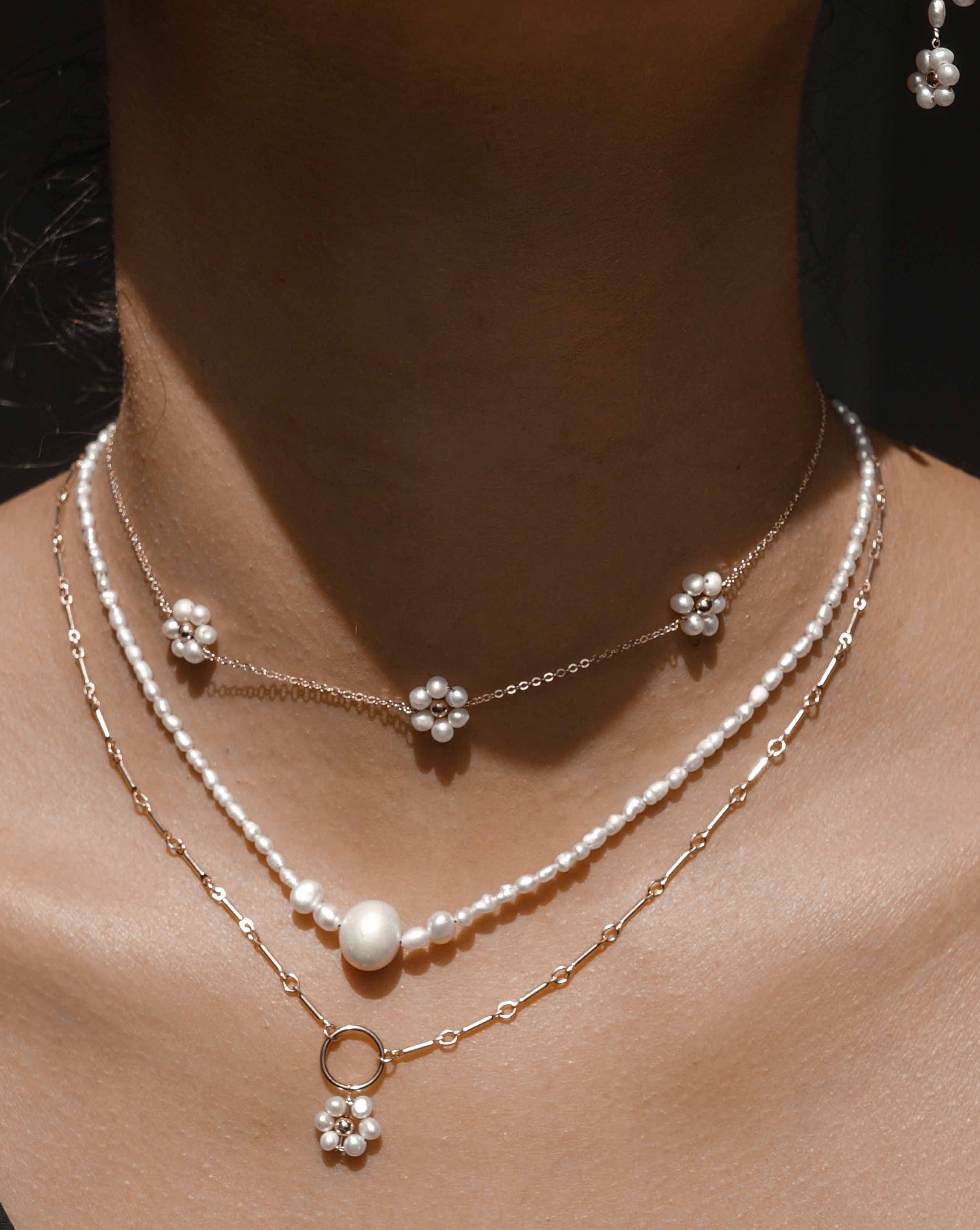 Fiores Choker Necklace by KOZAKH. A 13.5 to 15.5 inch adjustable length choker necklace, crafted in 14K Gold Filled, featuring 3mm Freshwater Pearls in form of daisies.