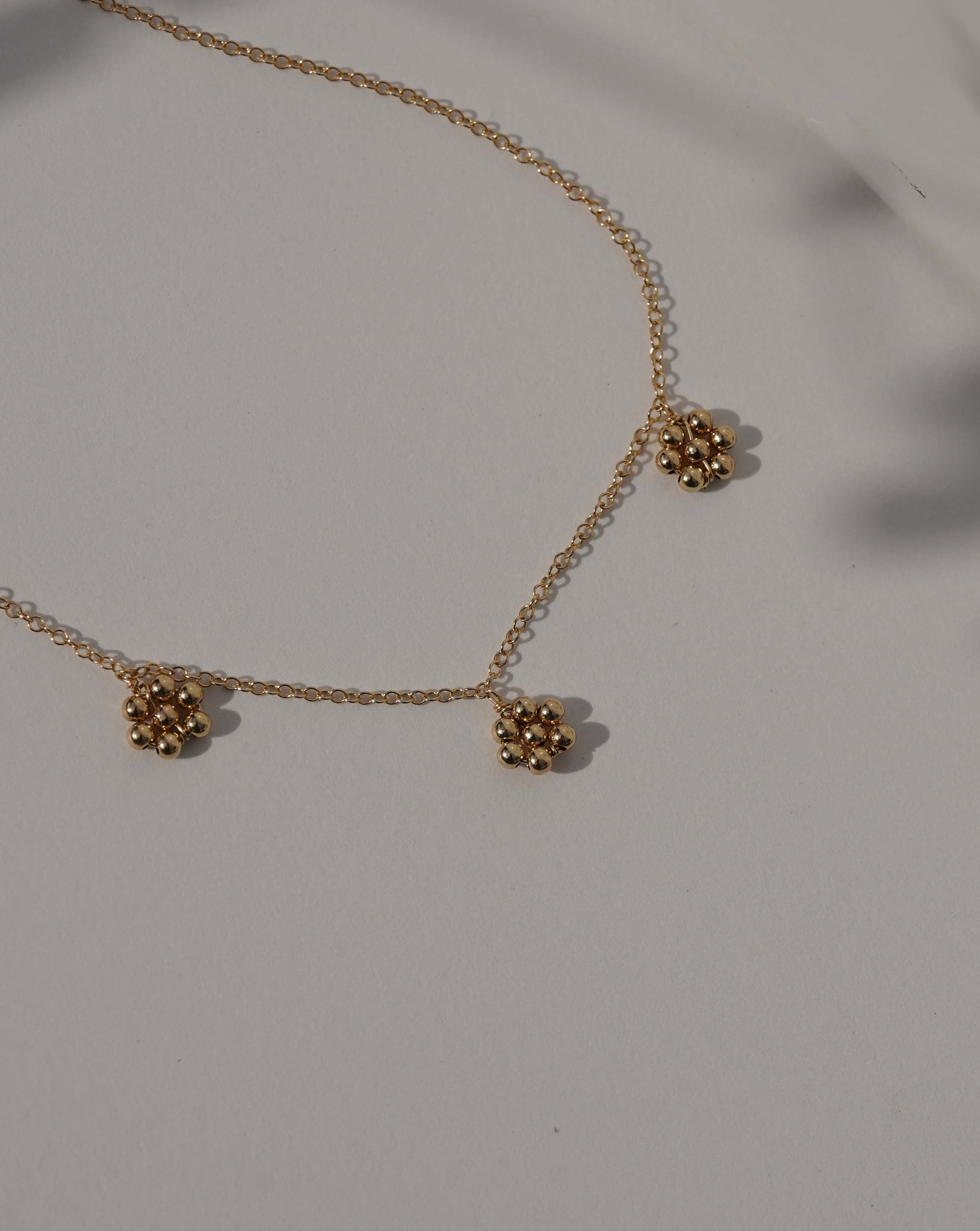 Flora Necklace by KOZAKH. A 16 to 18 inch adjustable length necklace in 14K Gold Filled, featuring handmade gold beaded daisies.