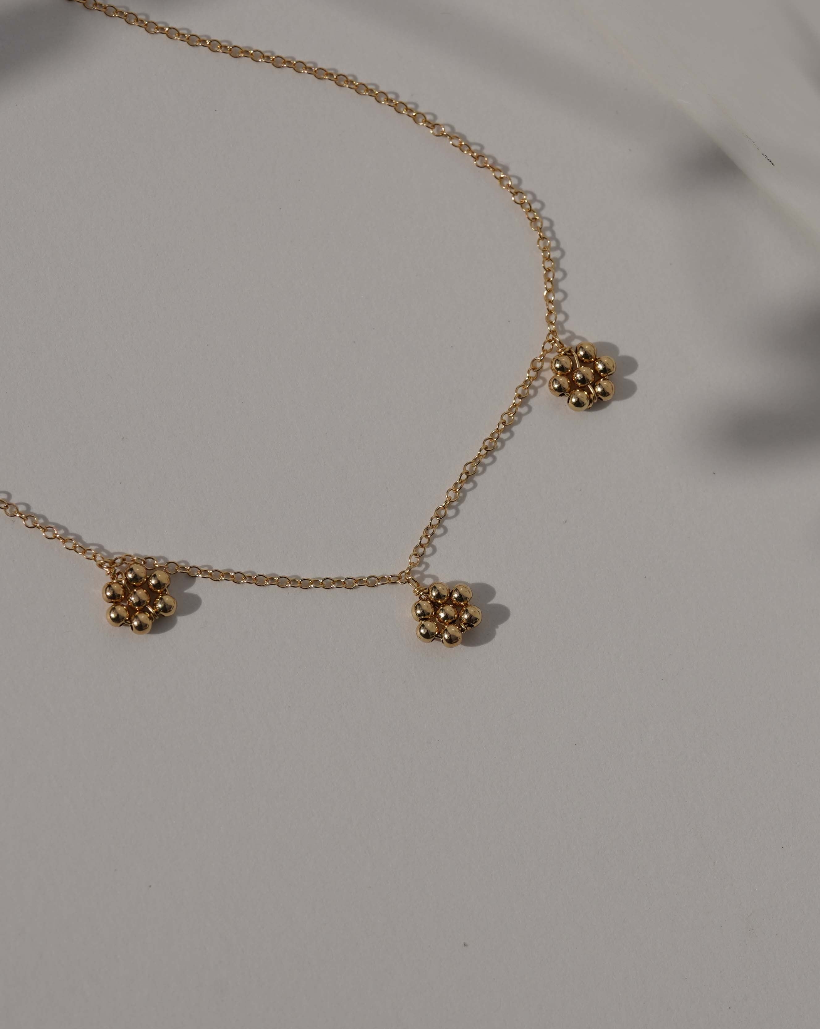 Flora Necklace by KOZAKH. A 16 to 18 inch adjustable length necklace in 14K Gold Filled, featuring handmade gold beaded daisies.