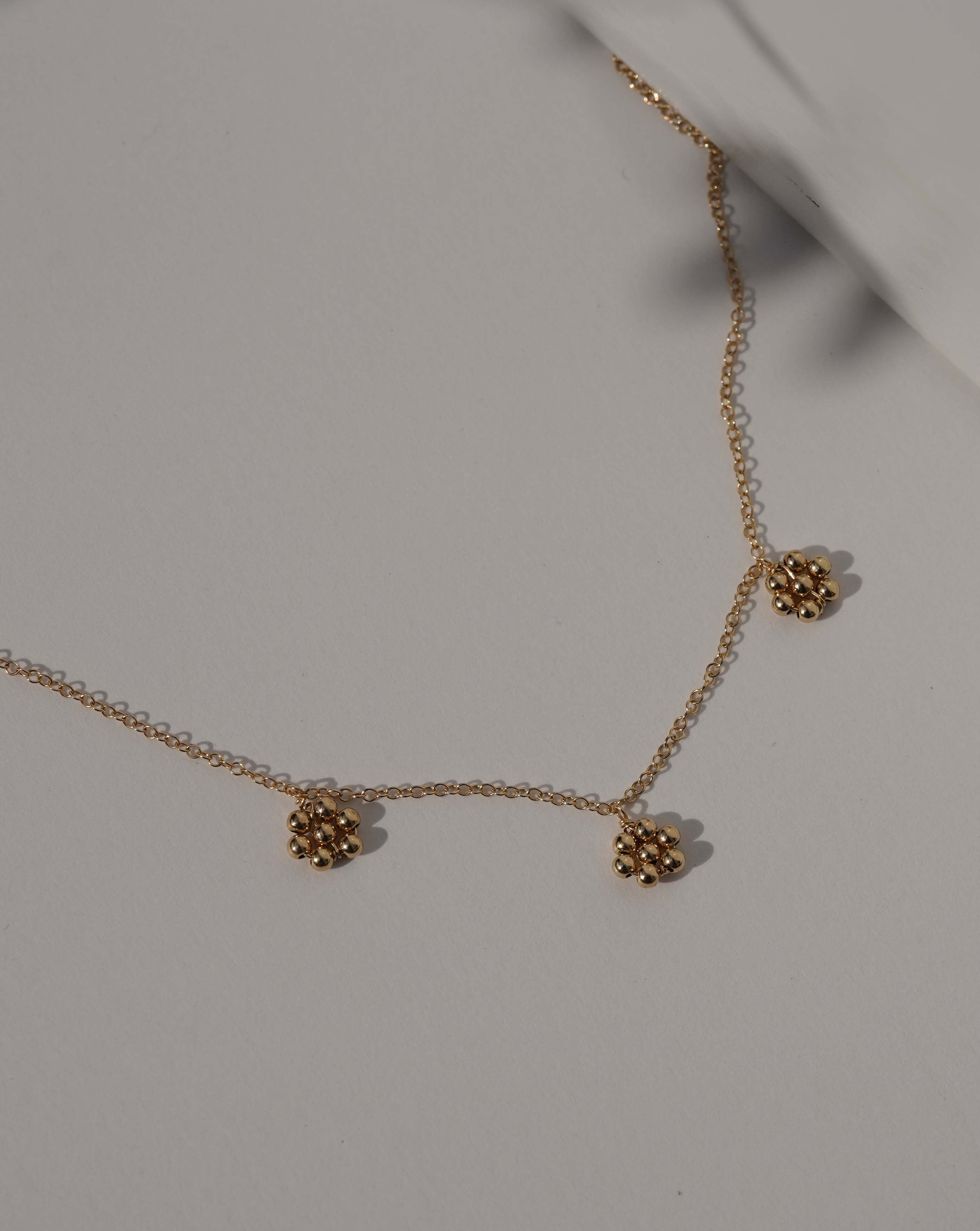 Flora Necklace by KOZAKH. A 16 to 18 inch adjustable length necklace in 14K Gold Filled, featuring handmade gold beaded daisies.