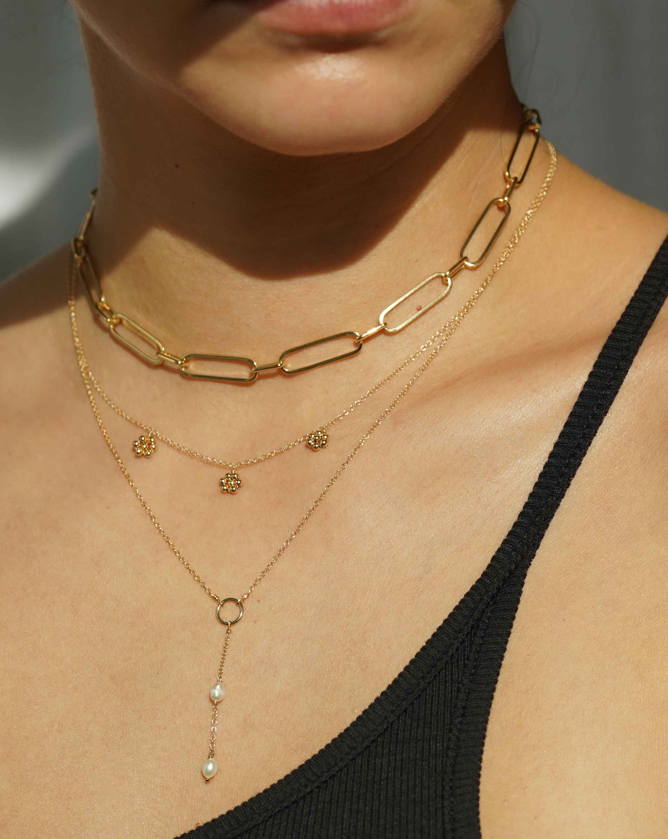 Flora Necklace by KOZAKH. A 16 to 18 inch adjustable length necklace in 14K Gold Filled, featuring handmade gold beaded daisies.