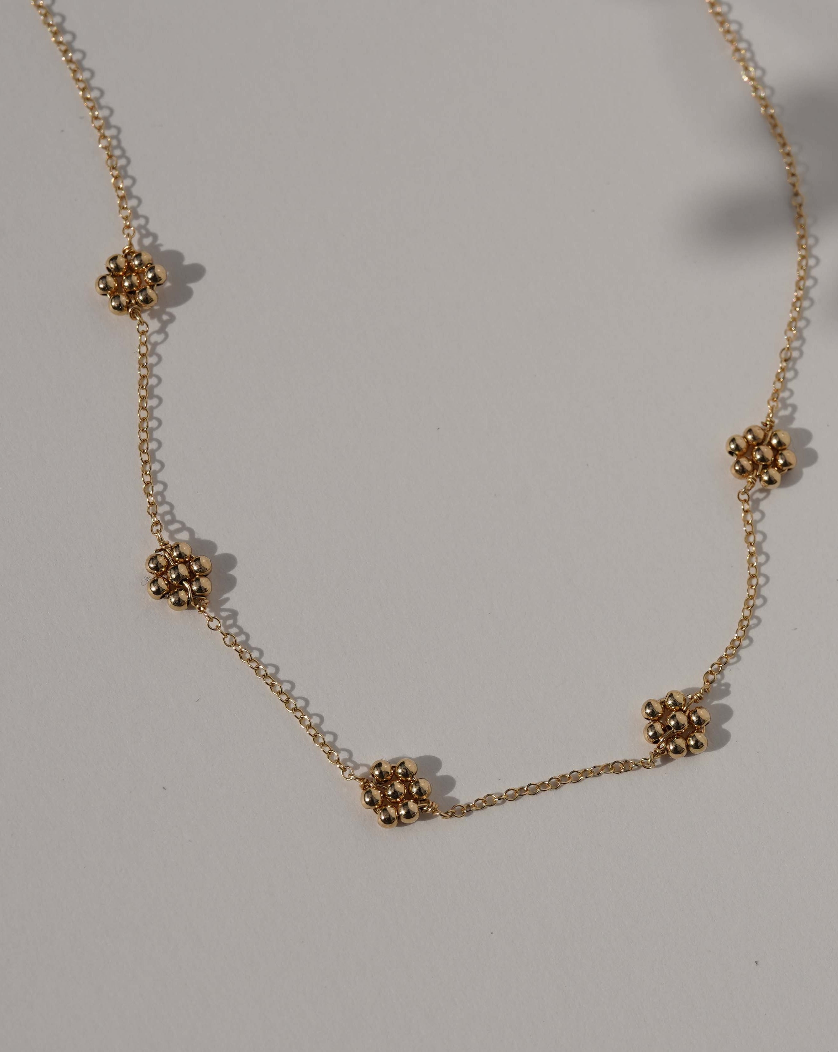 Florencia Necklace by KOZAKH. A 16 to 18 inch adjustable length necklace in 14K Gold Filled, featuring handmade gold beaded daisies.