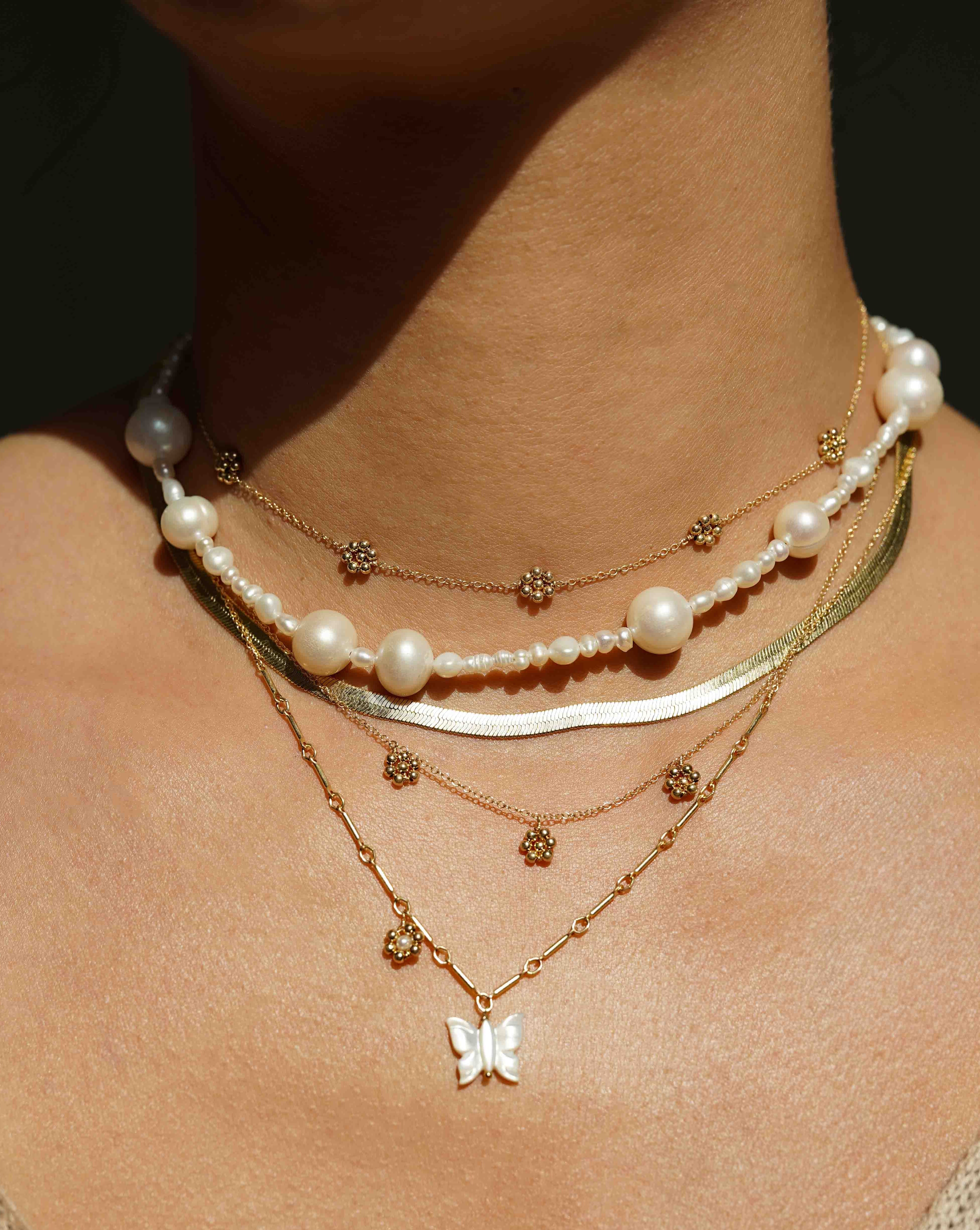 Florencia Necklace by KOZAKH. A 16 to 18 inch adjustable length necklace in 14K Gold Filled, featuring handmade gold beaded daisies.