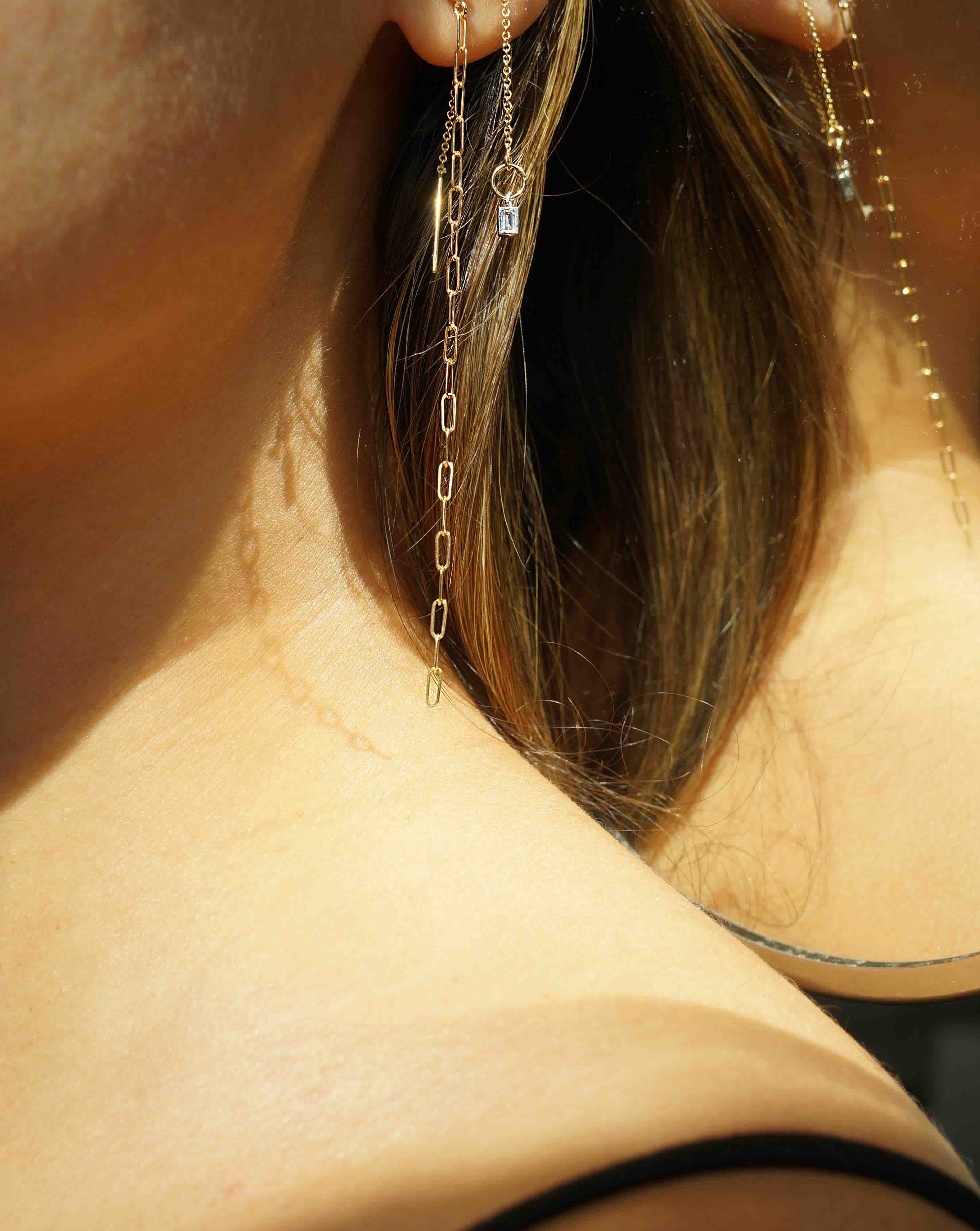 Grace Threaders by KOZAKH. Threader style earrings with drop length of 1 inch on both sides, crafted in 14K Gold Filled, featuring a square cut Cubic Zirconia.