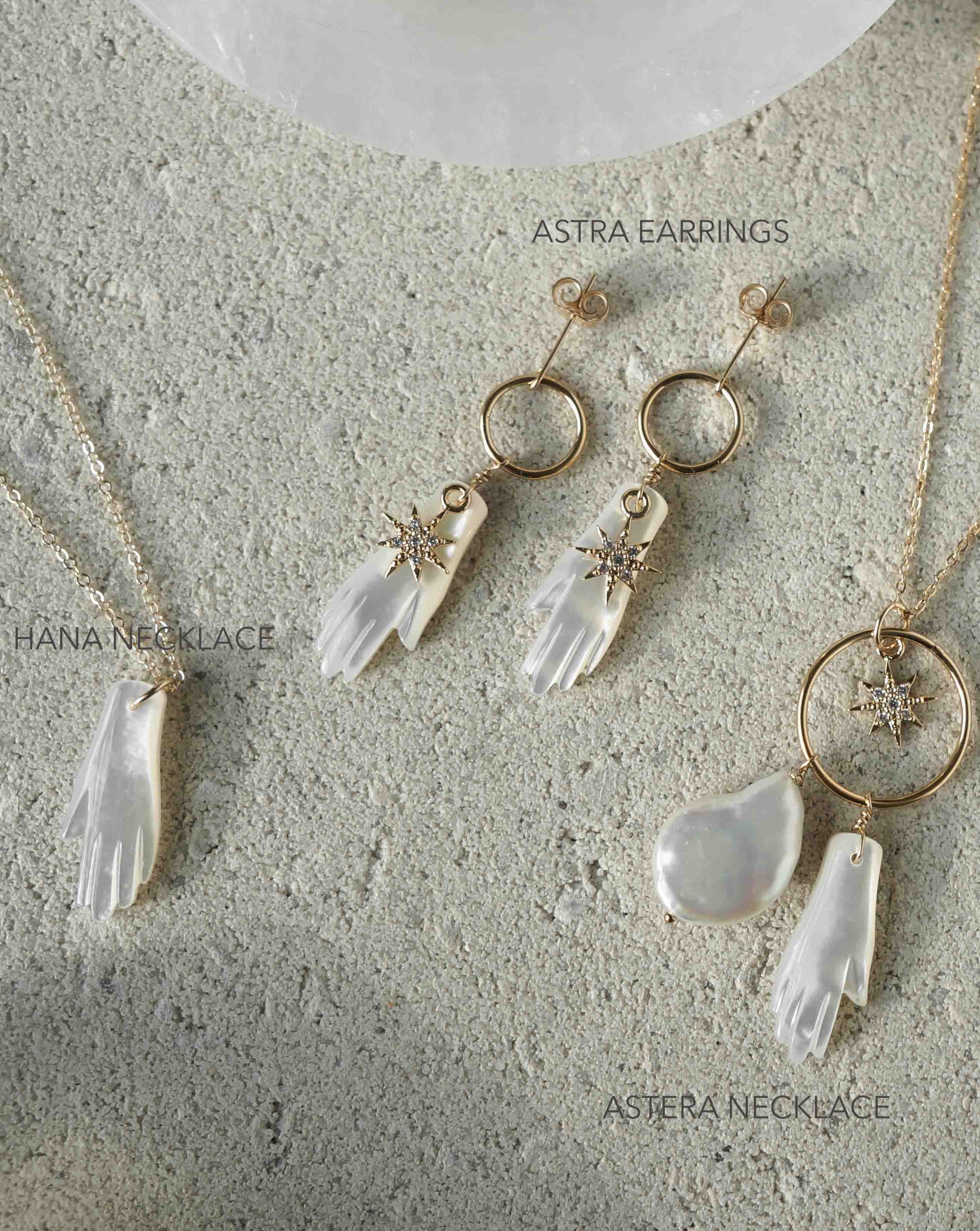 Hana Necklace by KOZAKH. A 16 to 18 inch adjustable length necklace in 14K Gold Filled, featuring a hand-carved Mother of Pearl hand charm.