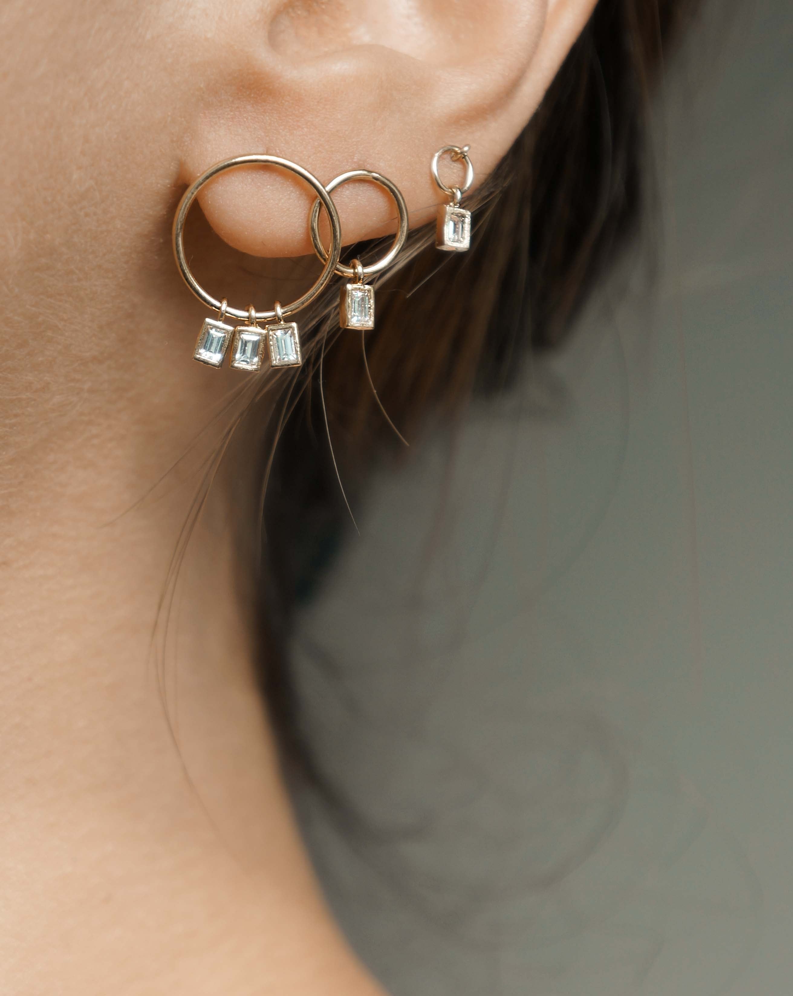 Hannah Earrings by KOZAKH. Mini hoop stud earrings with dangly square cut Cubic Zirconia, crafted in 14K Gold Filled.
