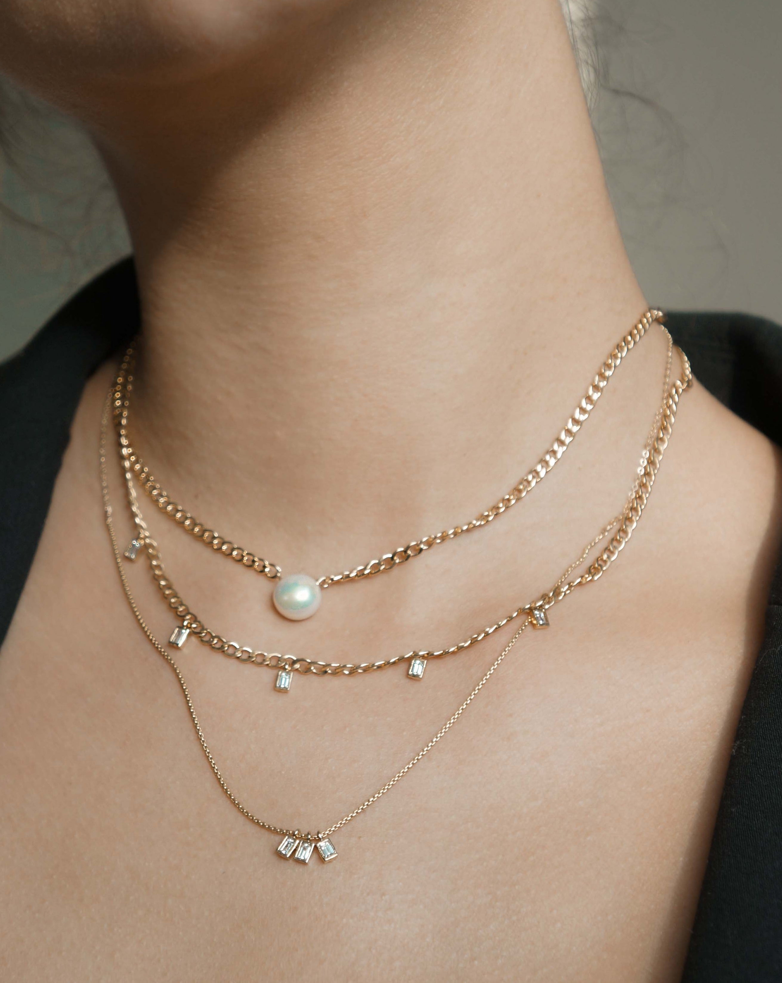 Harper Necklace by KOZAKH. A 16 to 18 inch adjustable length braided chain necklace in 14K Gold Filled, featuring a flat backed Freshwater Pearl.