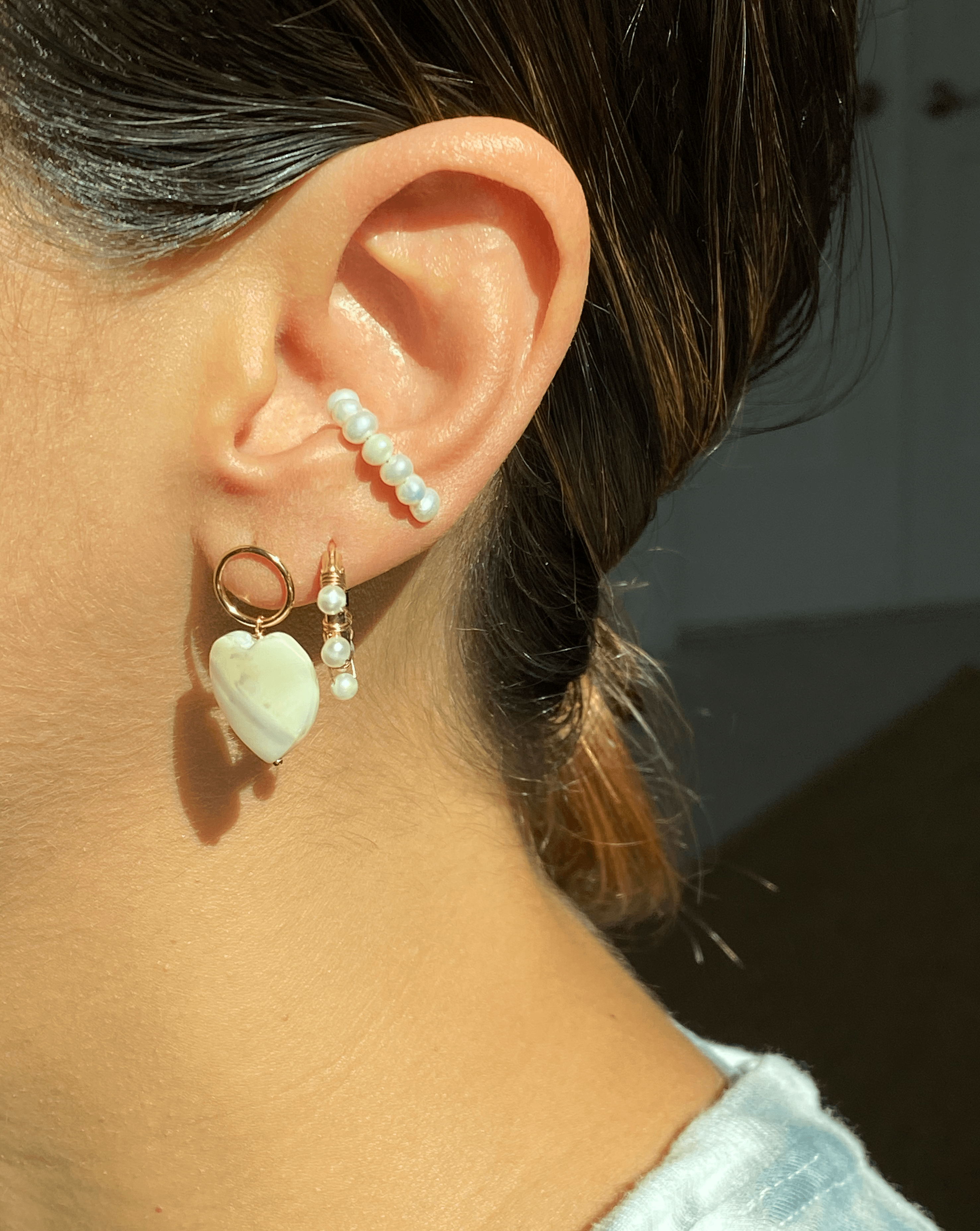 Heart Earrings by KOZAKH. Stud earrings, crafted in 14K Gold Filled, with hoop and hand carved faceted Mother of Pearl heart charm.