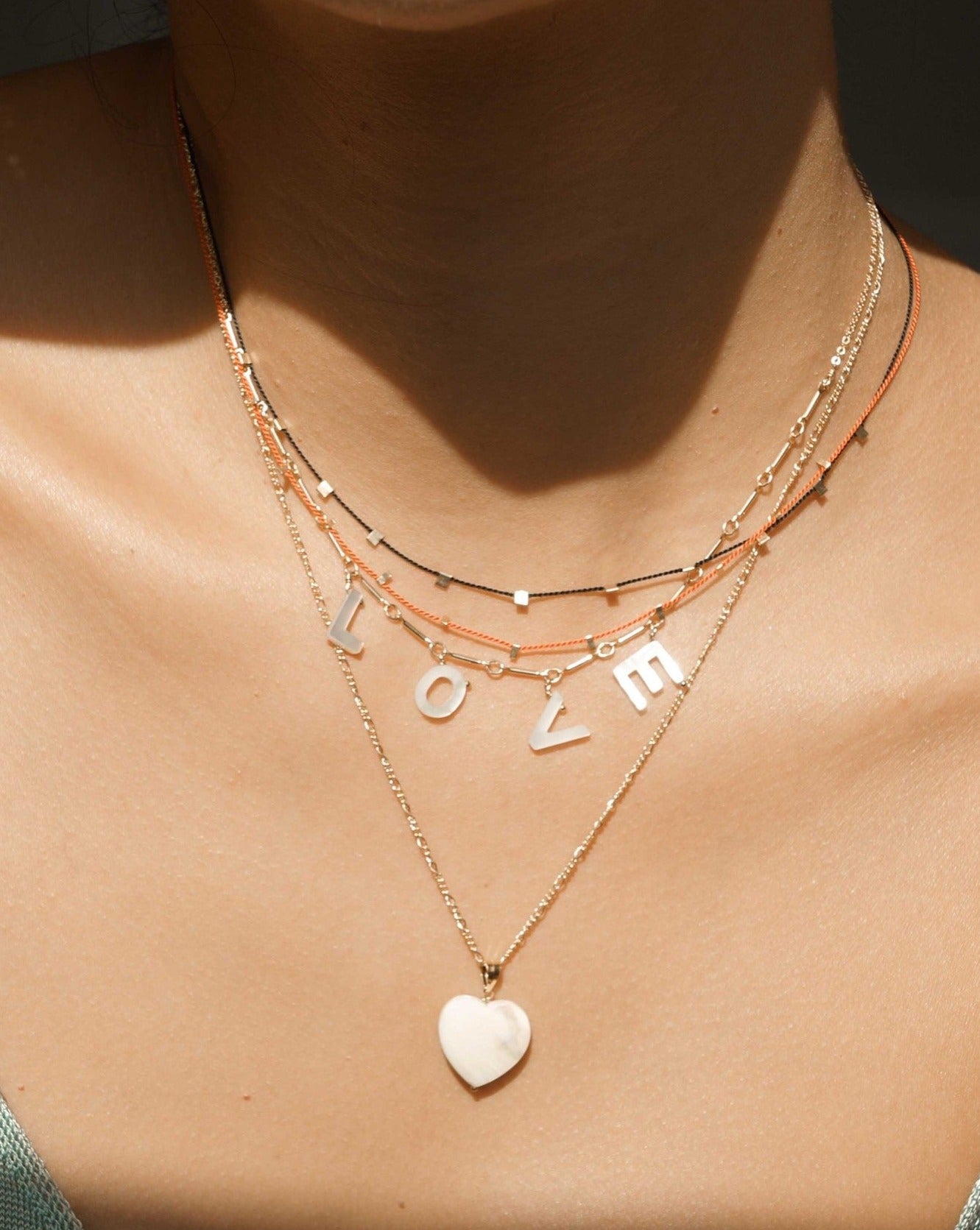 Heart Necklace by KOZAKH. A 16 to 18 inch adjustable length necklace in 14K Gold Filled, featuring a hand carved faceted Mother of Pearl heart charm.