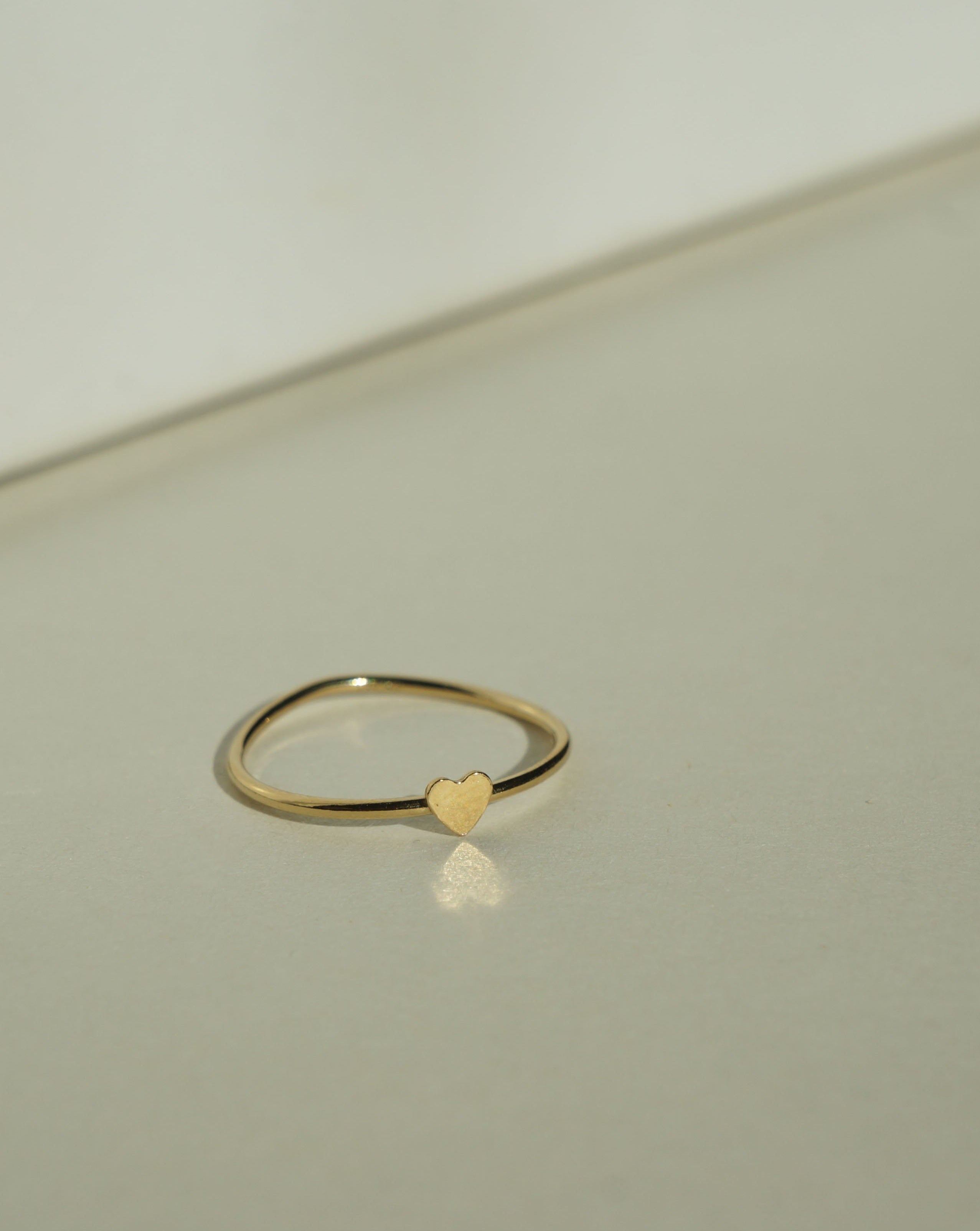 Heart Ring by KOZAKH. A 1mm band, crafted in 14K Gold Filled, featuring a gold heart design.