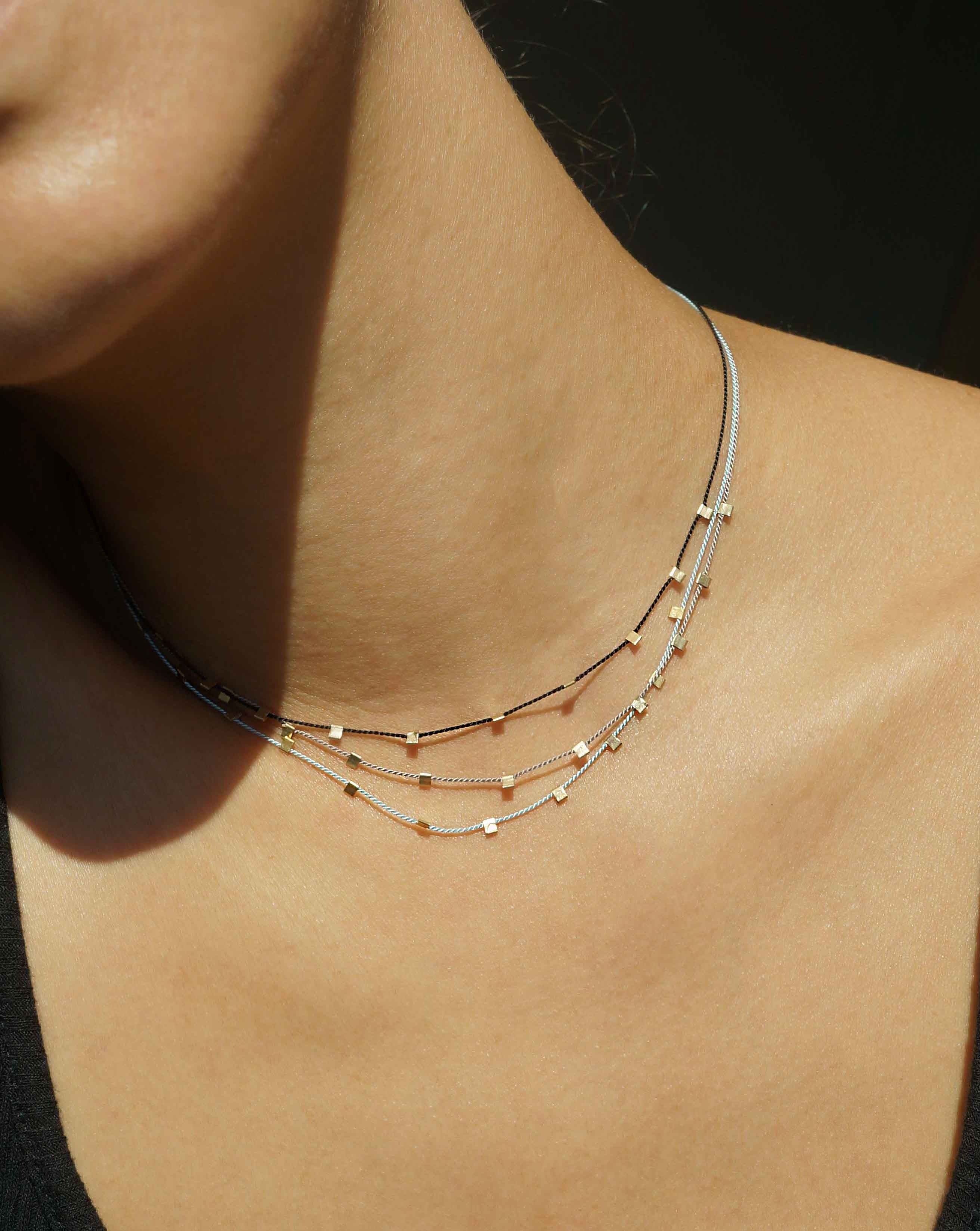 Hilo Necklace by KOZAKH. A 16 inch long natural silk thread necklace, embellished with 14K Gold Filled square cut metals.