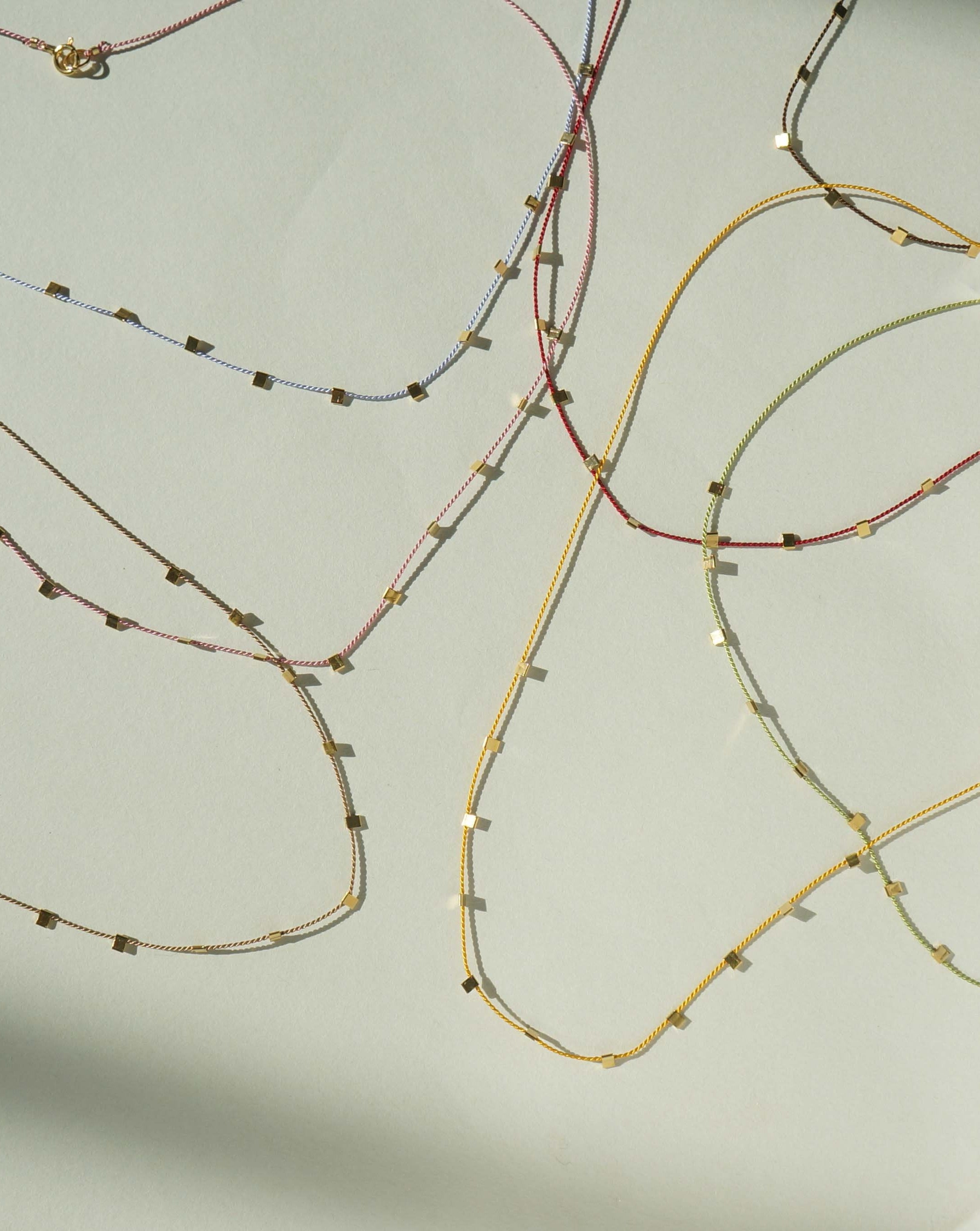 Hilo Necklace by KOZAKH. A 16 inch long natural silk thread necklace, embellished with 14K Gold Filled square cut metals.