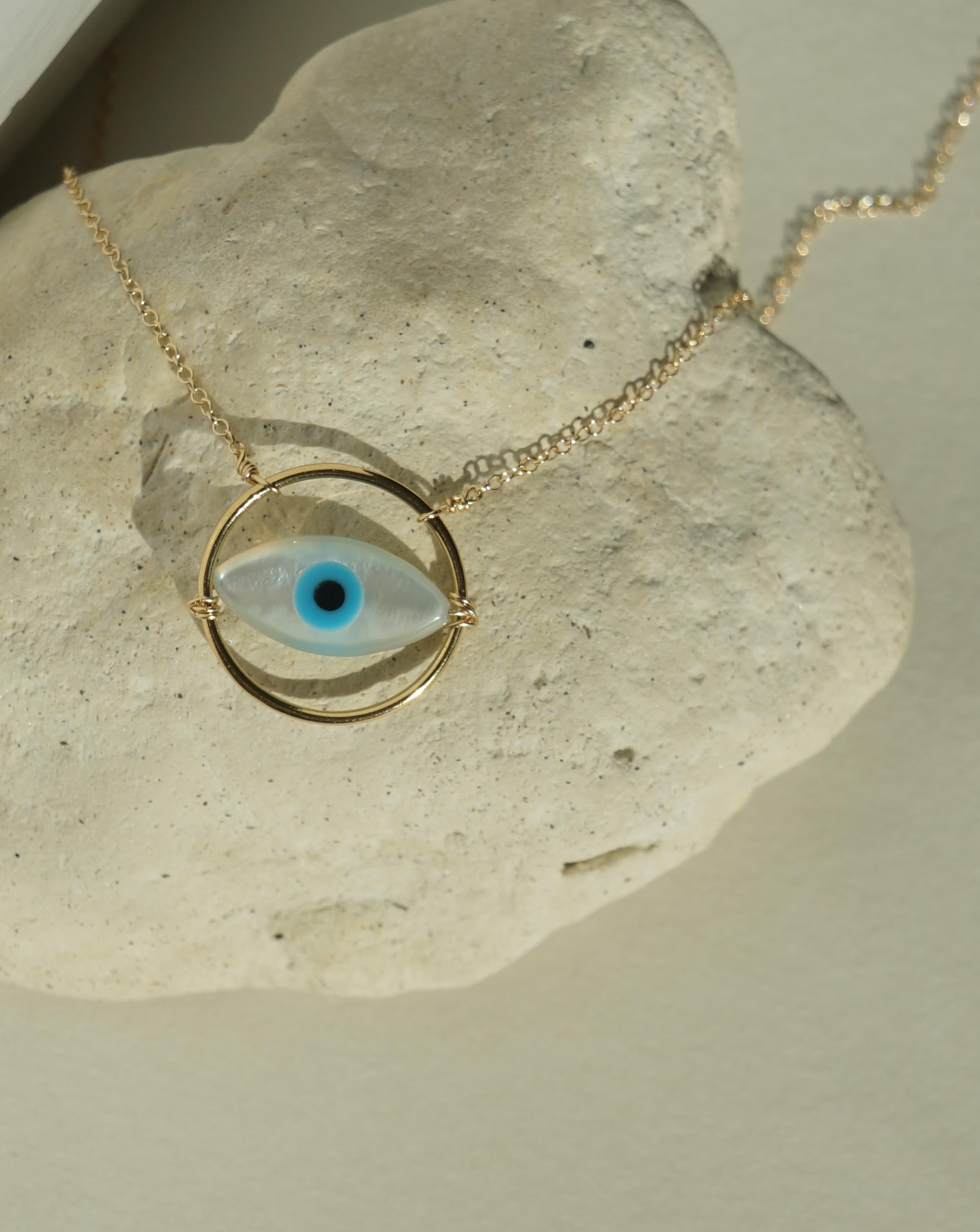 Ino Necklace by KOZAKH. A 16 to 18 inch adjustable length necklace in 14K Gold Filled, featuring a hand carved Mother of Pearl Evil Eye charm inside a ring.