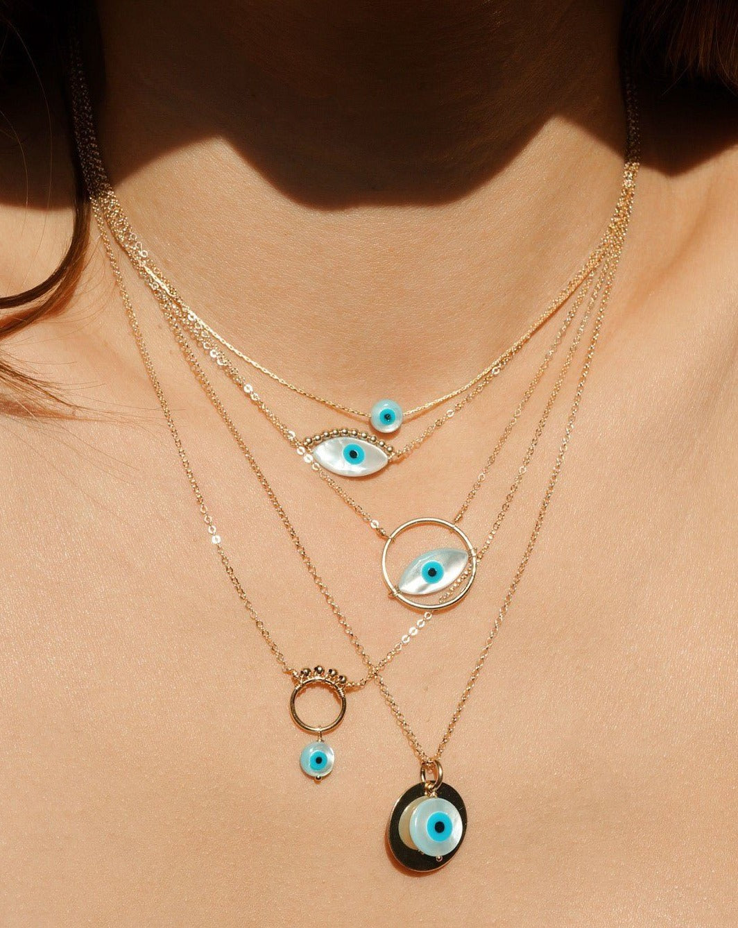Ira Necklace by KOZAKH. A 16 to 18 inch adjustable length necklace in 14K Gold Filled, featuring a hand carved Mother of Pearl Evil Eye charm and 2mm Seamless gold beads.