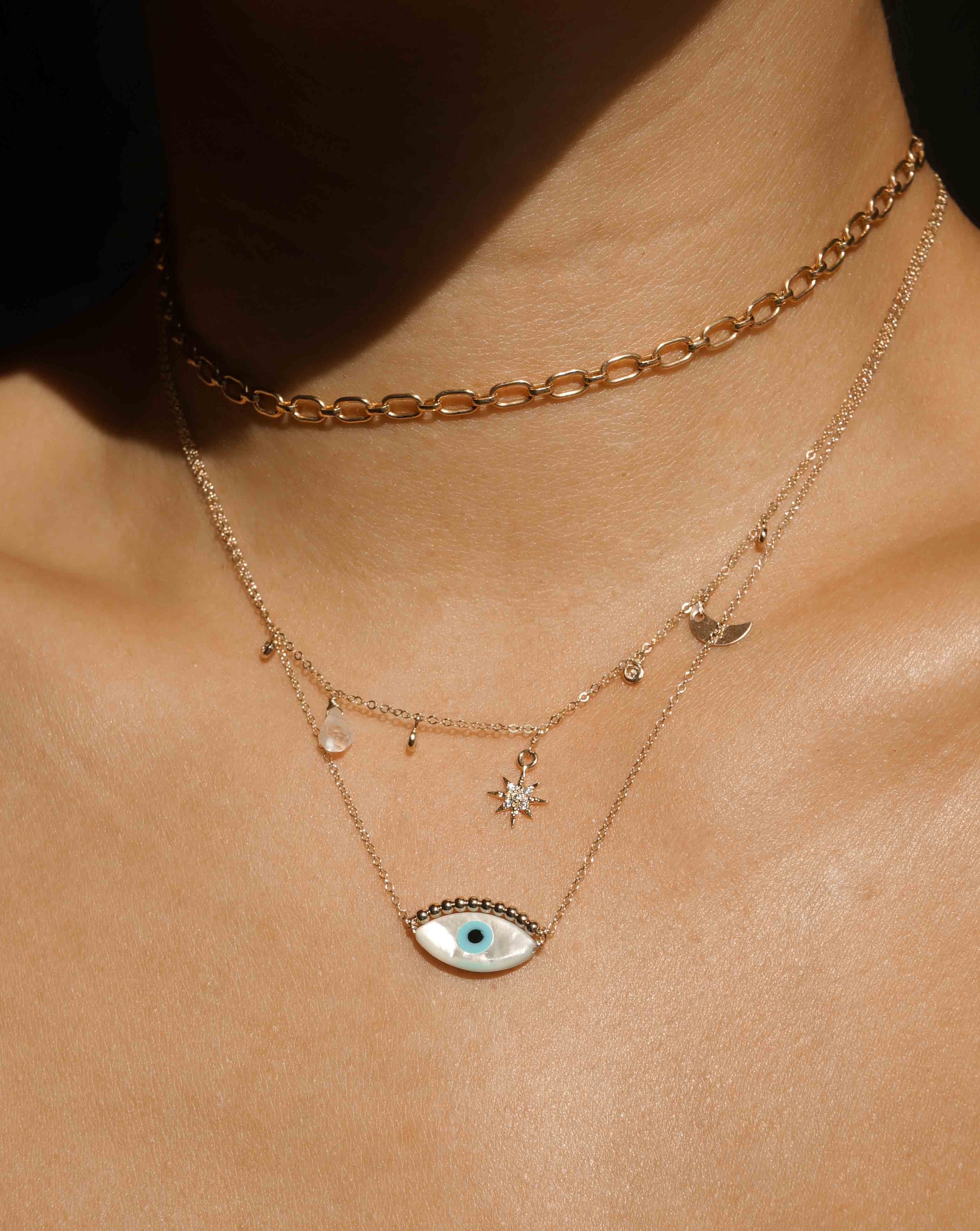 Ira Necklace by KOZAKH. A 16 to 18 inch adjustable length necklace in 14K Gold Filled, featuring a hand carved Mother of Pearl Evil Eye charm and 2mm Seamless gold beads.