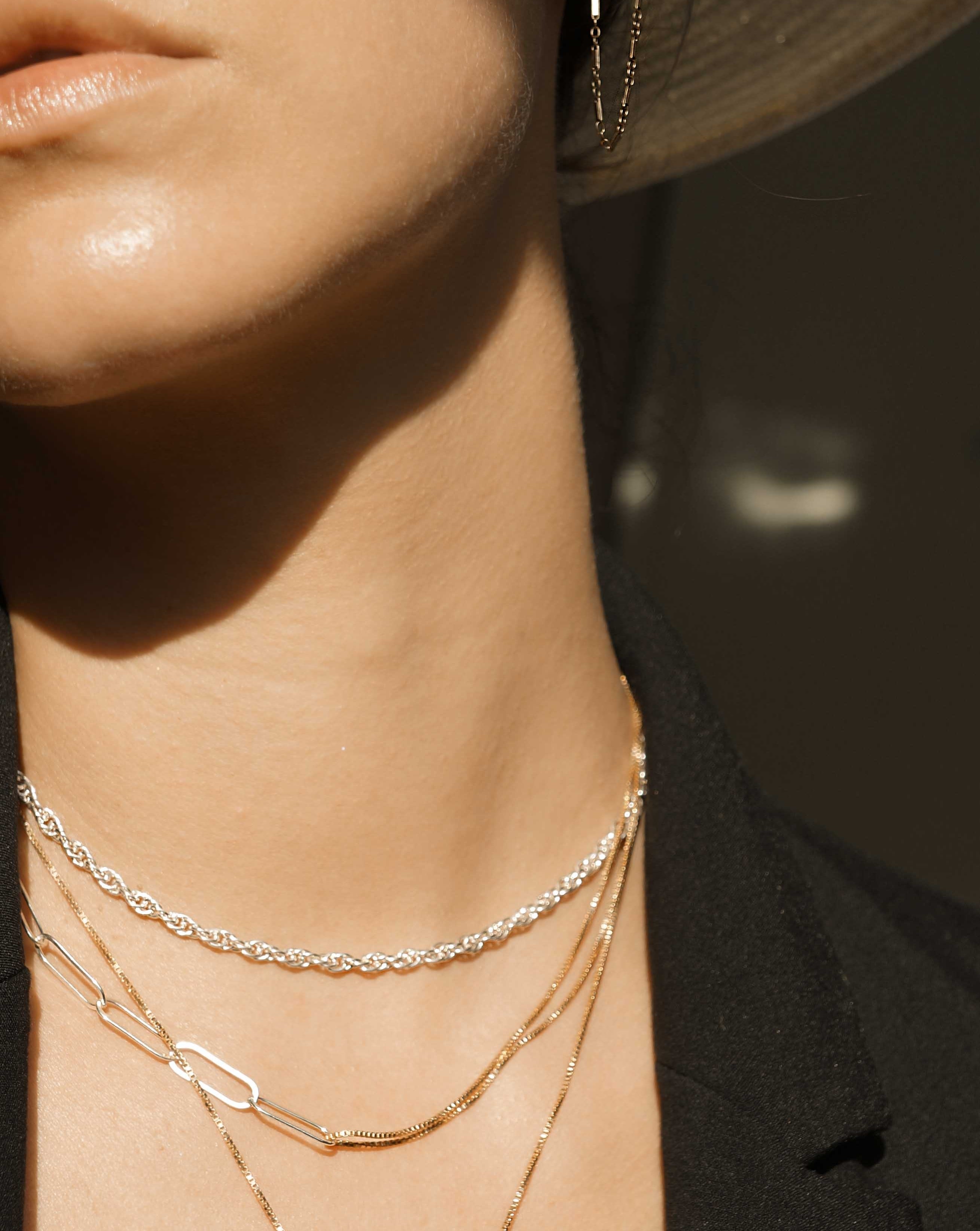 Isabella Necklace by KOZAKH. A 14 to 16 inch adjustable length combo chain necklace with gold box chain and silver paperclip chain. The Flat Link Chain is in Sterling Silver chain and the 1mm Box chain is in 14k Gold Filled.