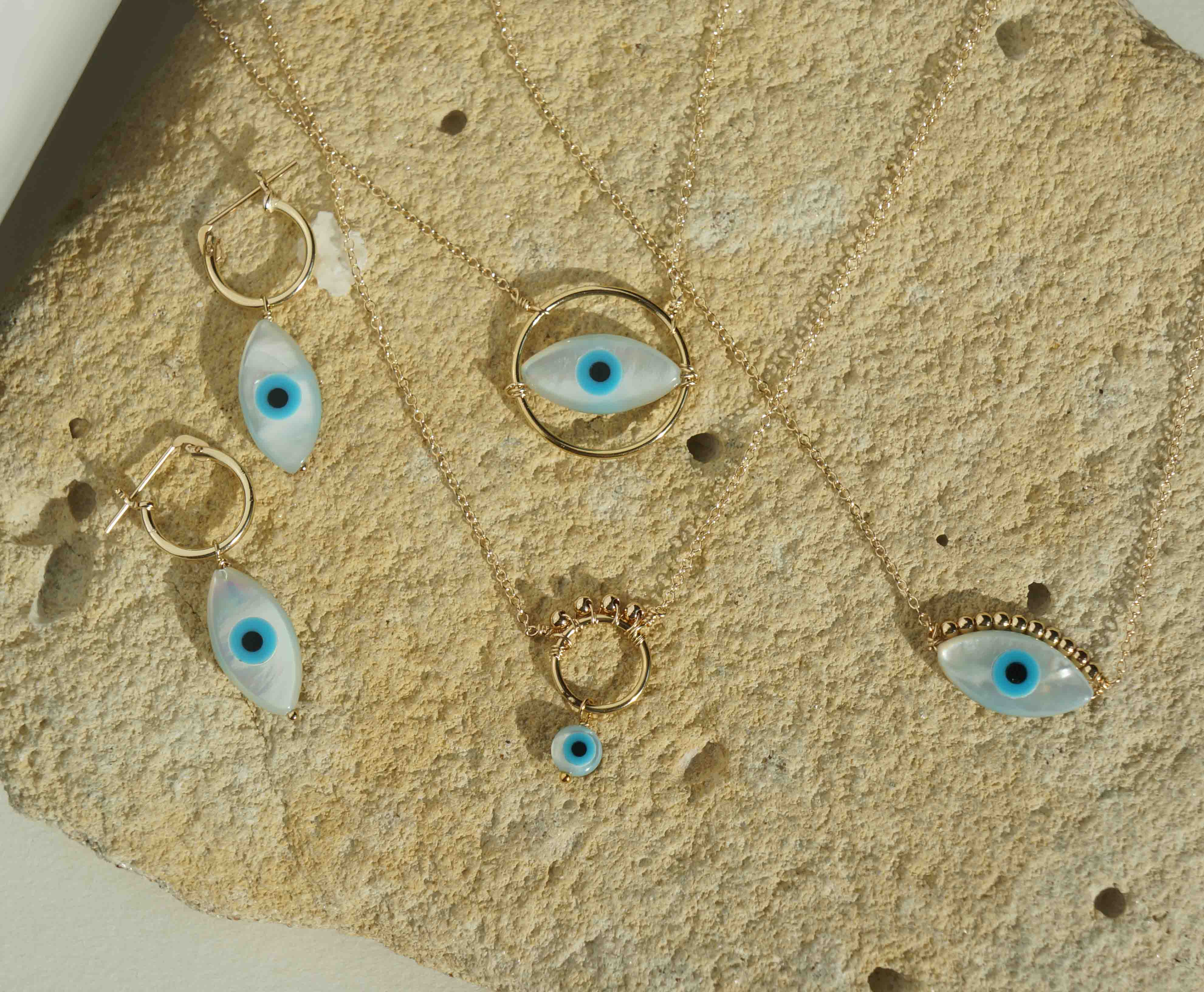 Ivy Necklace by KOZAKH. A 16 to 18 inch adjustable length necklace in 14K Gold Filled, featuring a hand carved Mother of Pearl Evil Eye charm and 2mm Seamless gold beads.