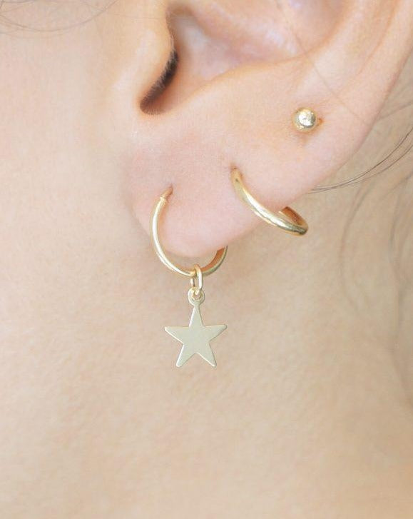 Kisstar Hoop Earrings by KOZAKH. 12mm hoop earrings, crafted in 14K Gold Filled, featuring a star charm.