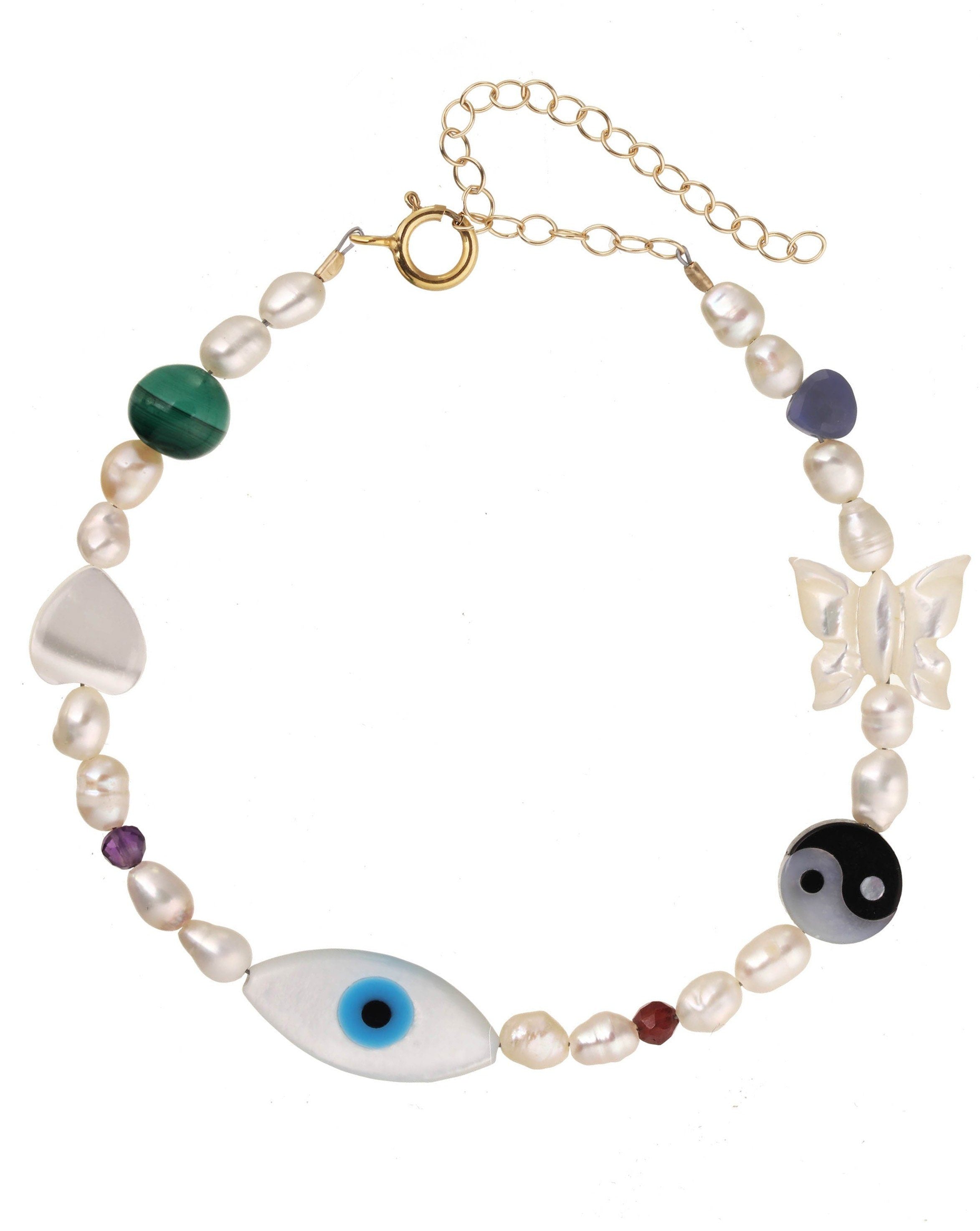 Lexie Bracelet by KOZAKH. A 6 to 7 inch adjustable length bracelet in 14K Gold Filled, featuring Pink Tourmaline slice, Mother of Pearl butterfly charm, round cut Malachite gemstone, Mother of Pearl eye charm, and 2.5mm to 3mm Fresh water pearls.