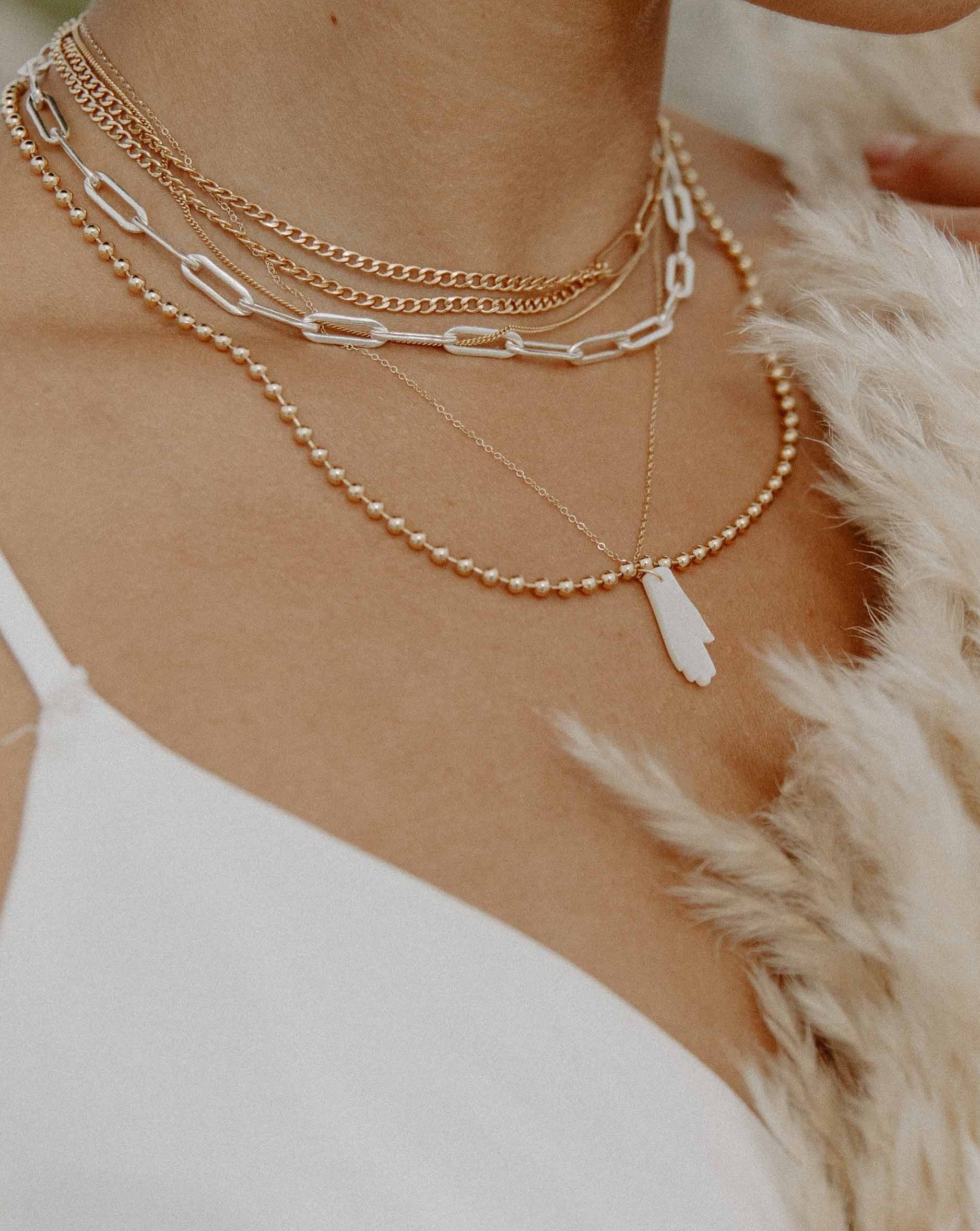 Lilian Necklace by KOZAKH. A 14 to 16 inch adjustable length, combo chain necklace in 14K Gold Filled, with half of it is braided chain and paperclip chain on the other half.