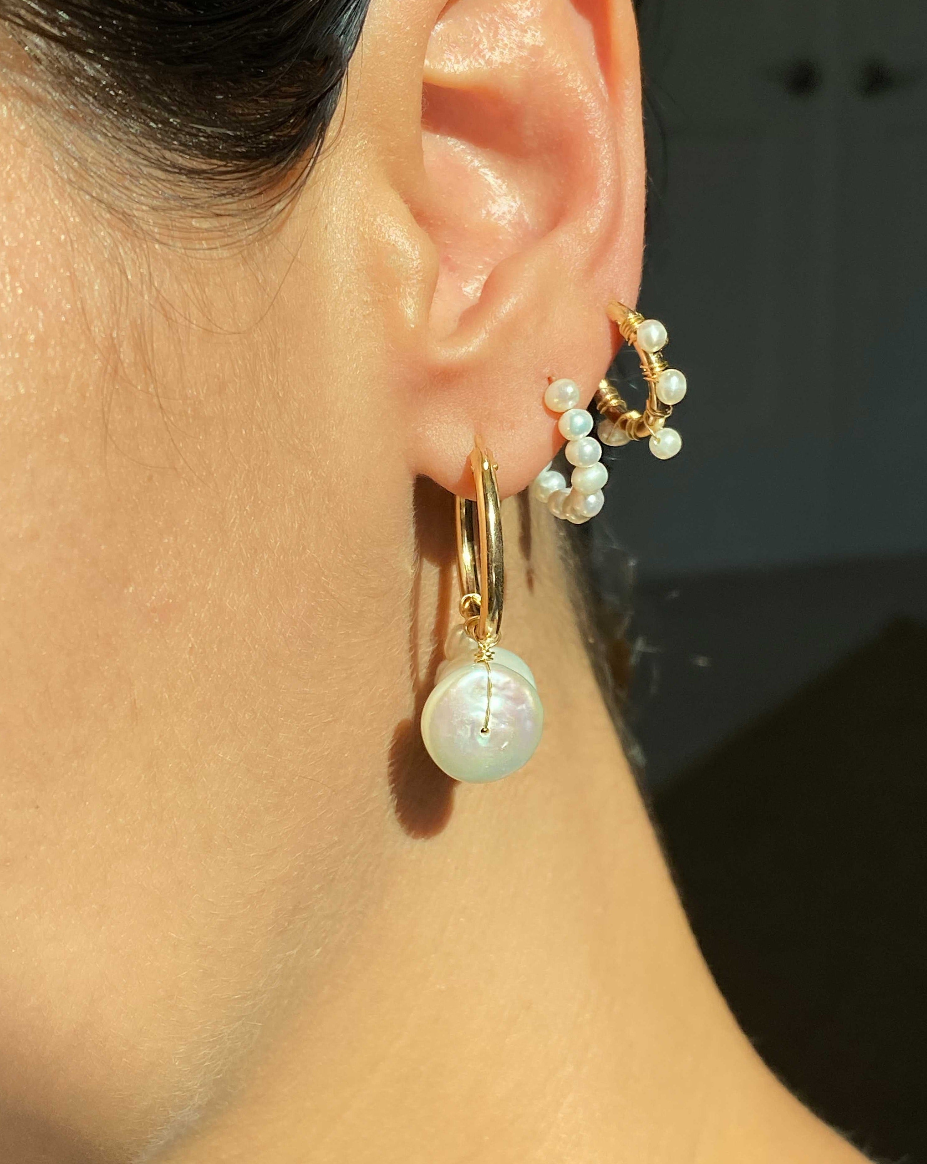 Lolo Hoops by KOZAKH. Stud earrings crafted in 14K Gold Filled, featuring 3mm white freshwater Pearls forming a hoop shape.