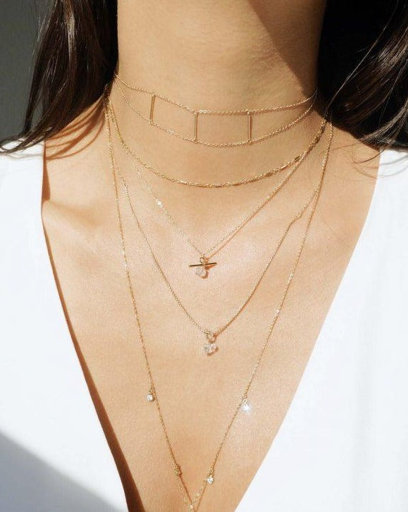 Love Knot Necklace by KOZAKH. A 16 to 18 inch adjustable length necklace, crafted in 14K Gold Filled, featuring a knot and a faceted Herkimer Diamond.