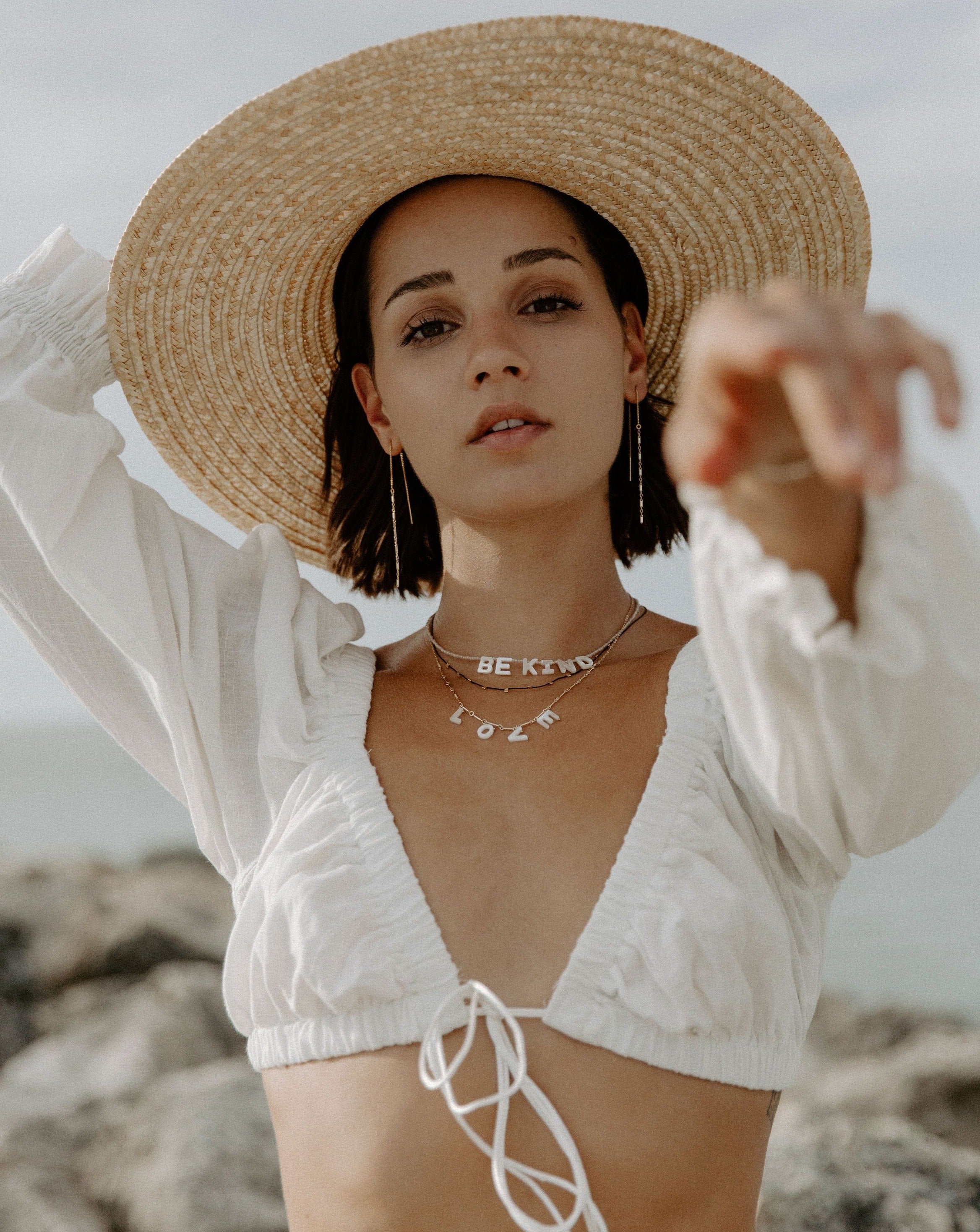 Love Necklace by KOZAKH. A 16 to 18 inch adjustable length necklace with linked bar chain on bottom half and flat link chain on top half, crafted in 14K Gold Filled, featuring a customizable word made from hand carved Mother of Pearl letters.