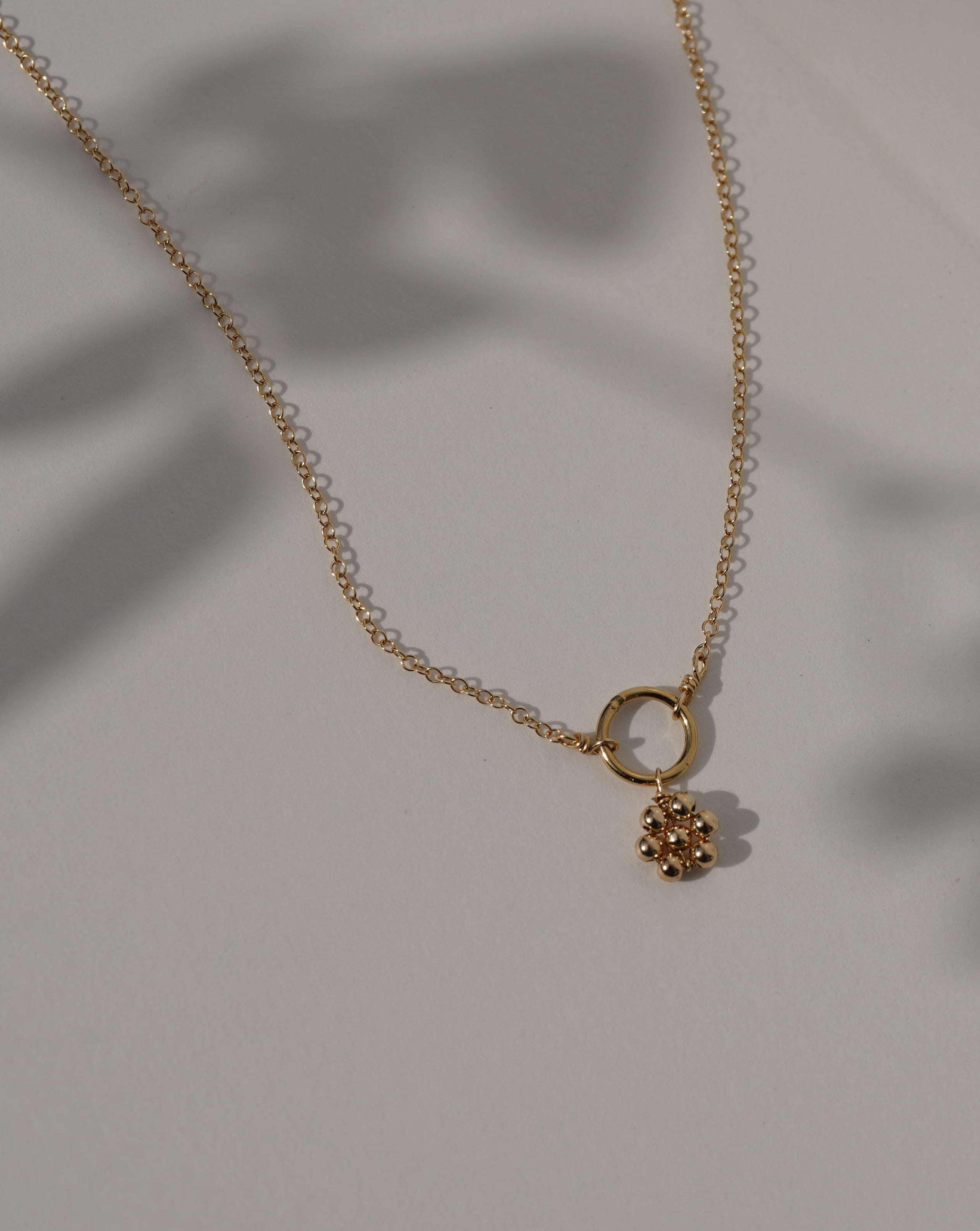 Luella Necklace by KOZAKH. A 16 to 18 inch adjustable length necklace, crafted in 14K Gold Filled, featuring a handmade beaded daisy charm.