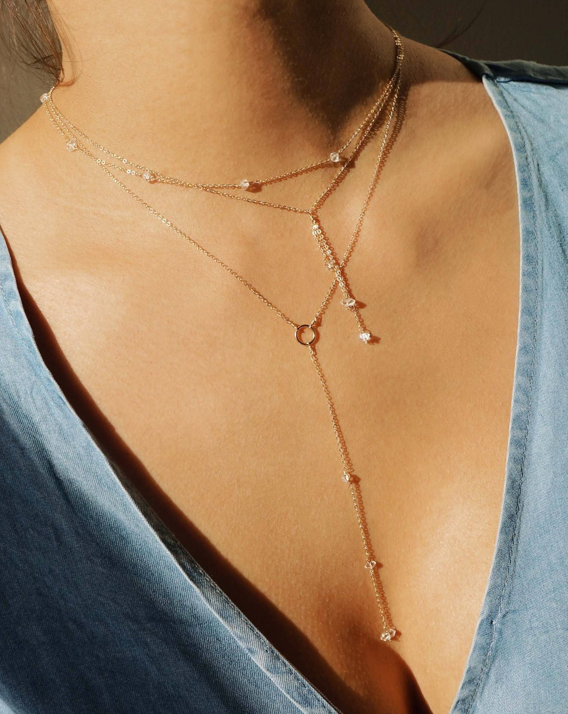 Miren Herkimer Necklace by KOZAKH. A 16 to 18 inch adjustable length, 2 inches drop lariat style necklace, crafted in 14K Gold Filled, featuring Herkimer Diamonds.