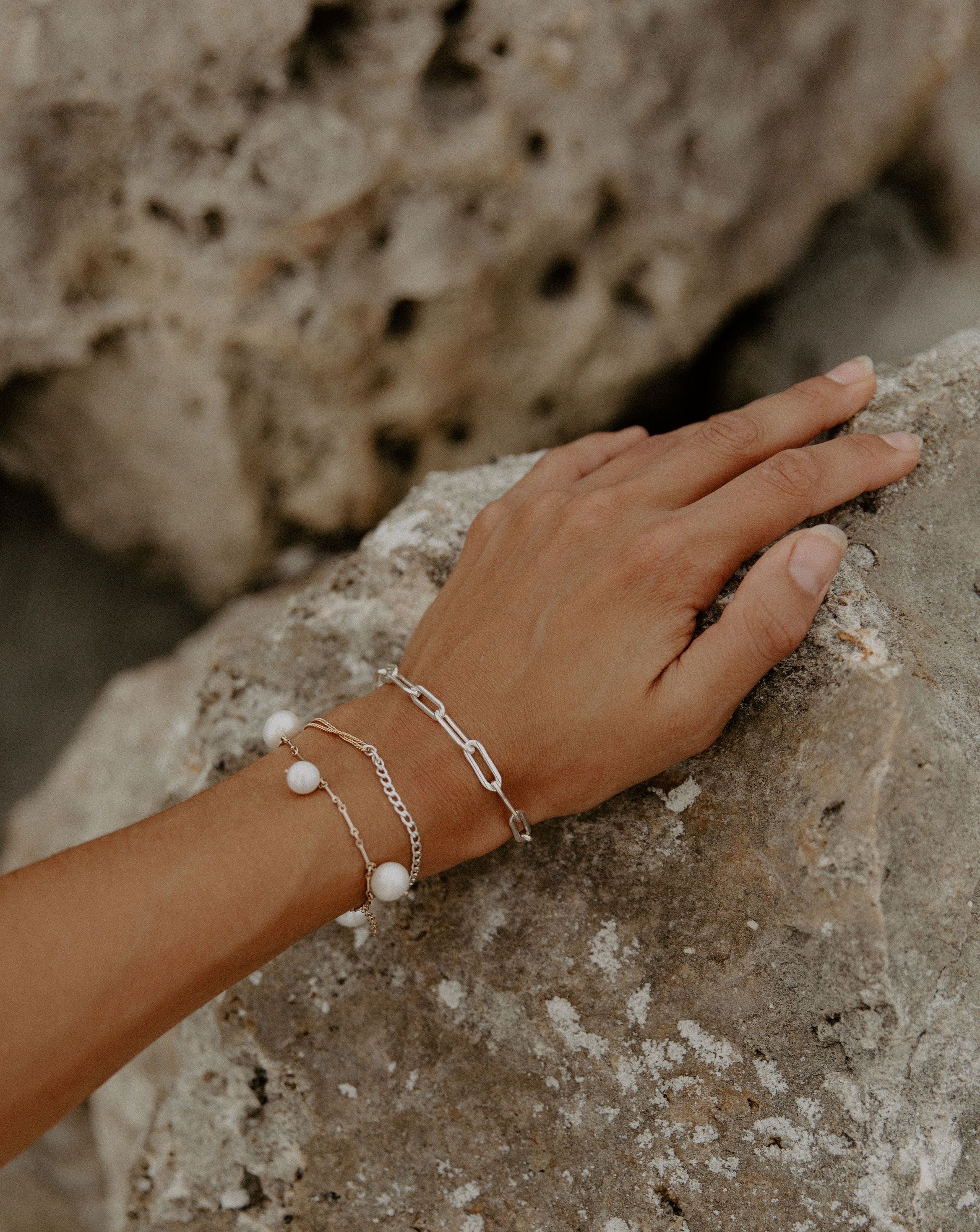 Moni Bracelet by KOZAKH. A 6 to 7 inch adjustable length two tone bracelet with 1mm Gold Filled flat curb chain on one half and 3mm Sterling Silver Cuban link chain on the other half.