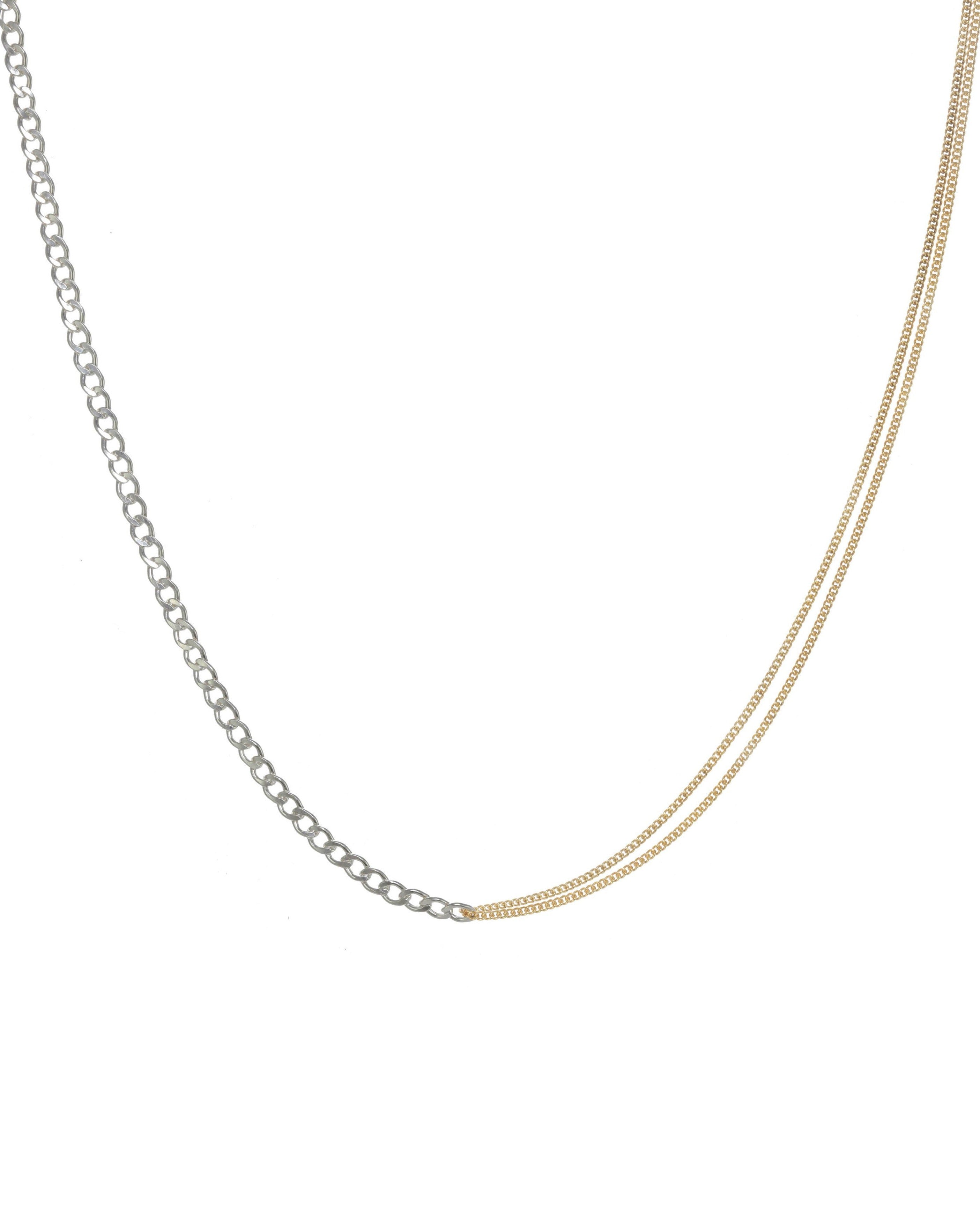 Monica Necklace by KOZAKH. A 14 to 16 inch adjustable length two tone necklace with gold box chain on one half and silver braided chain on the other half.