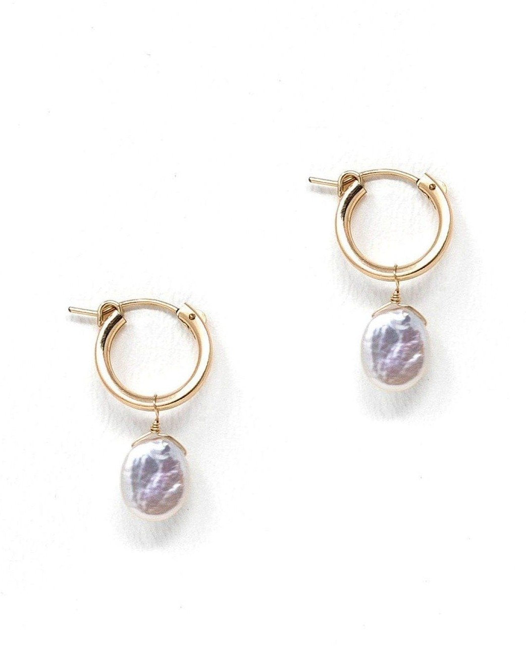 Nancy Hoop Earrings by KOZAKH. 15mm snap closure hoop earrings in 14K Gold Filled, featuring a 13mm flat oval Pearl.