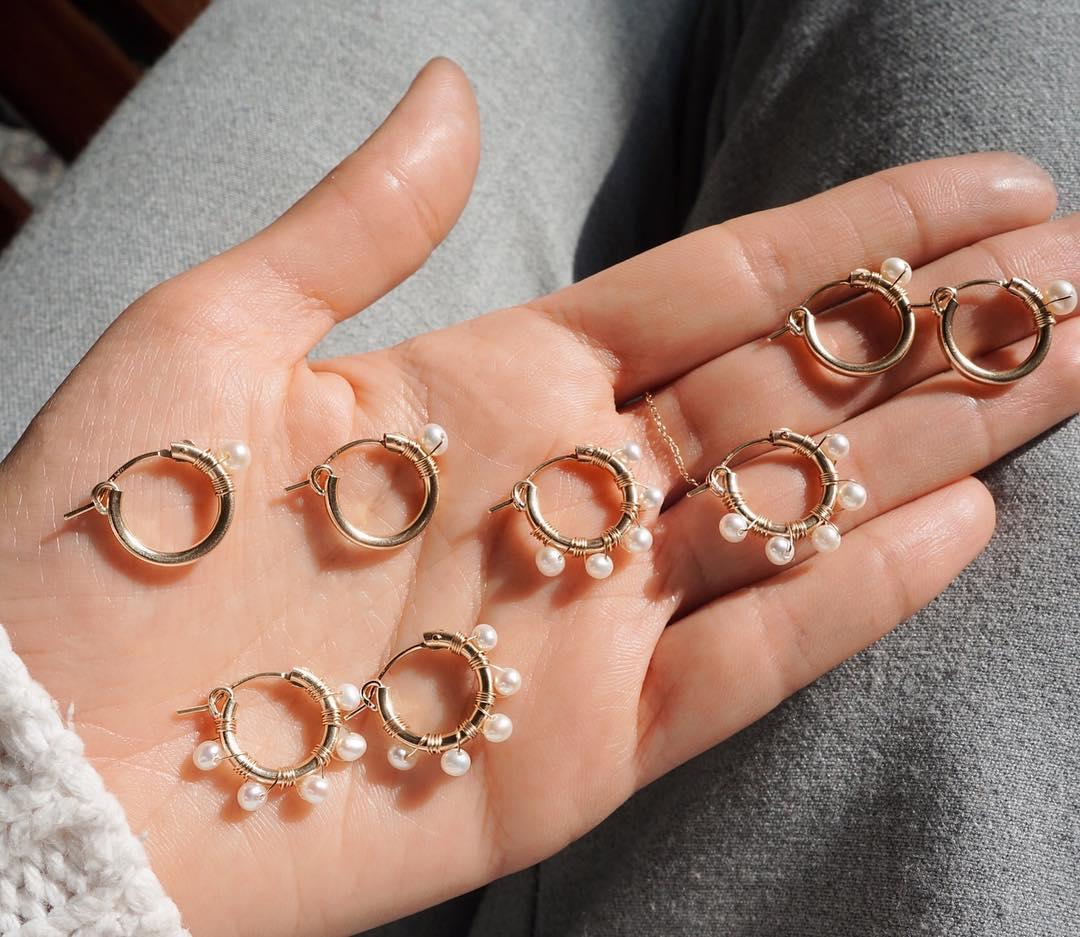 Natasha Hoop Earrings by KOZAKH. 12mm snap closure hoop earrings in 14K Gold Filled, featuring 7mm white potato Pearls.
