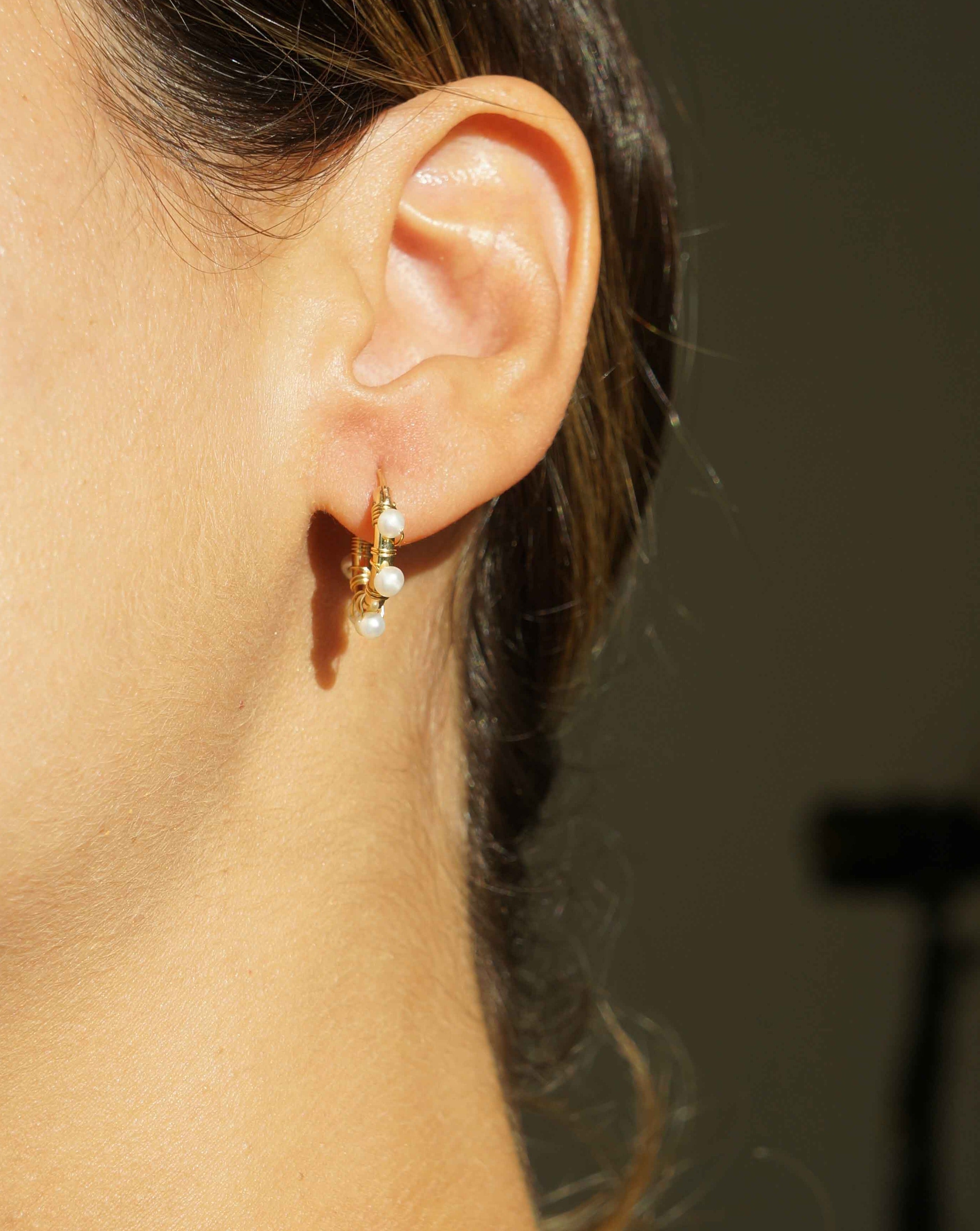 Natasha Hoop Earrings by KOZAKH. 12mm snap closure hoop earrings in 14K Gold Filled, featuring 7mm white potato Pearls.