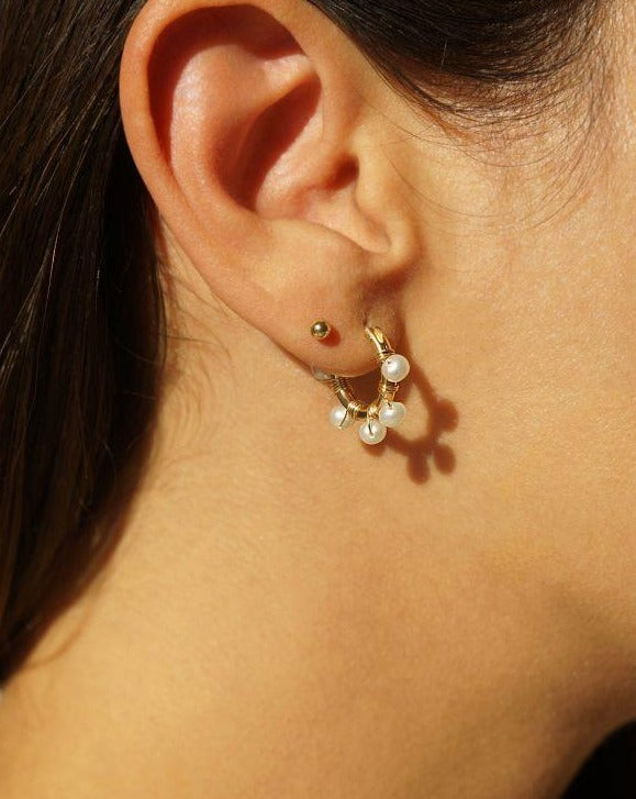 Natasha Hoop Earrings by KOZAKH. 12mm snap closure hoop earrings in 14K Gold Filled, featuring 7mm white potato Pearls.