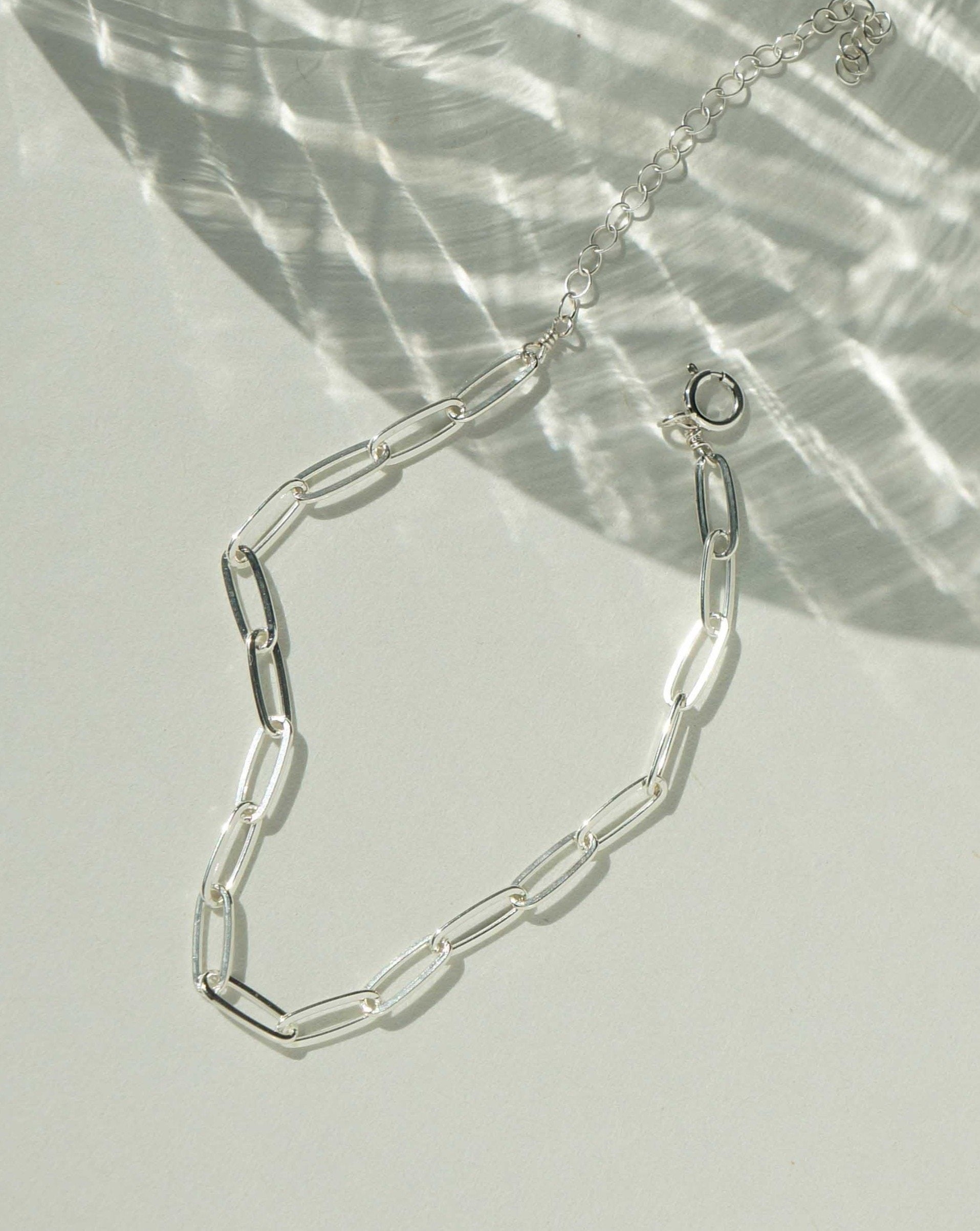 Norita Bracelet by KOZAKH. A 6 to 7 inch adjustable length, thin flat link paperclip style chain bracelet, crafted in Sterling Silver.